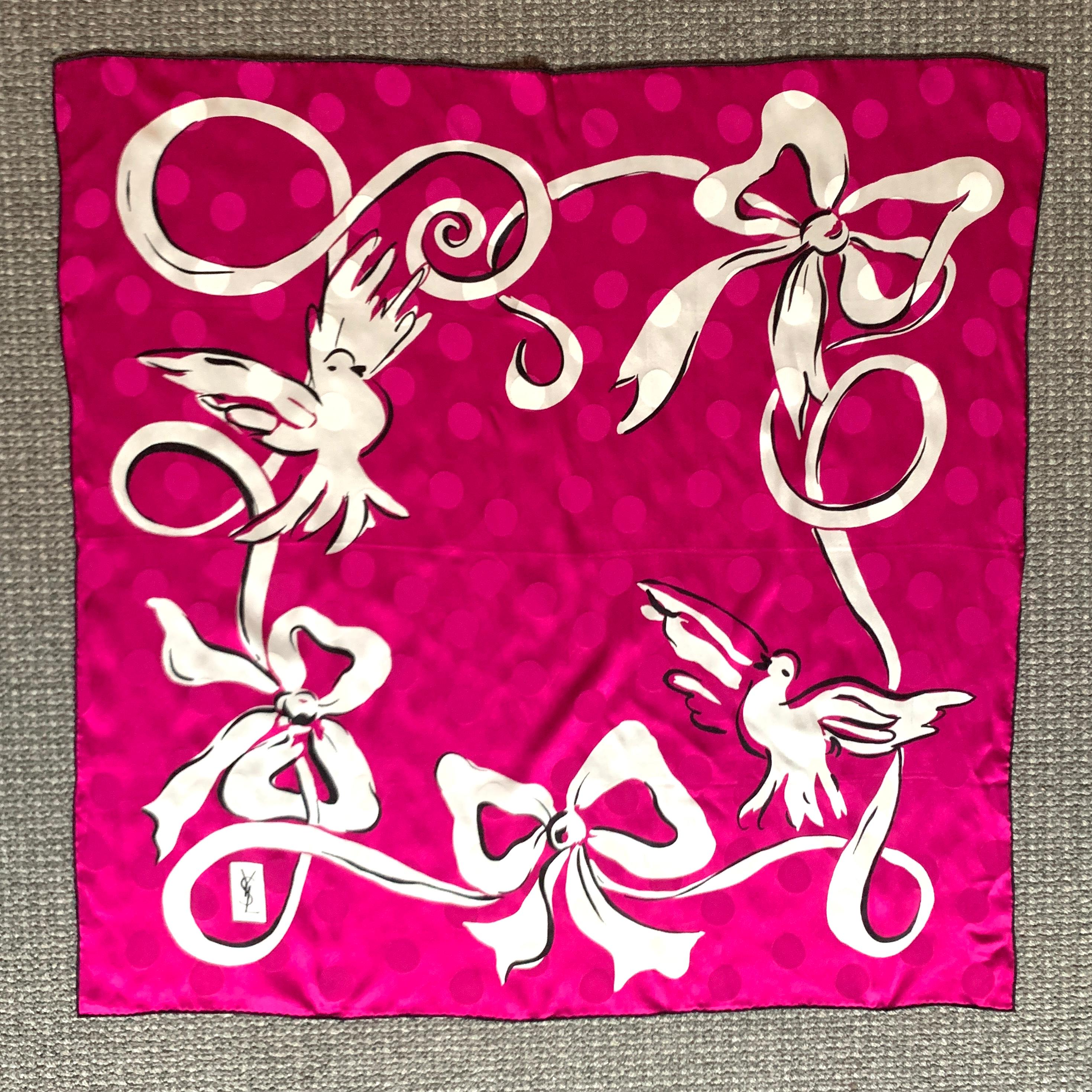 Yves Saint Laurent vintage scarf in a magenta and white dove and ribbon print, featuring jacquard polkadots throughout and black edges. YSL logo at bottom left corner.

100% silk.

Made in Italy.

Approximately 34