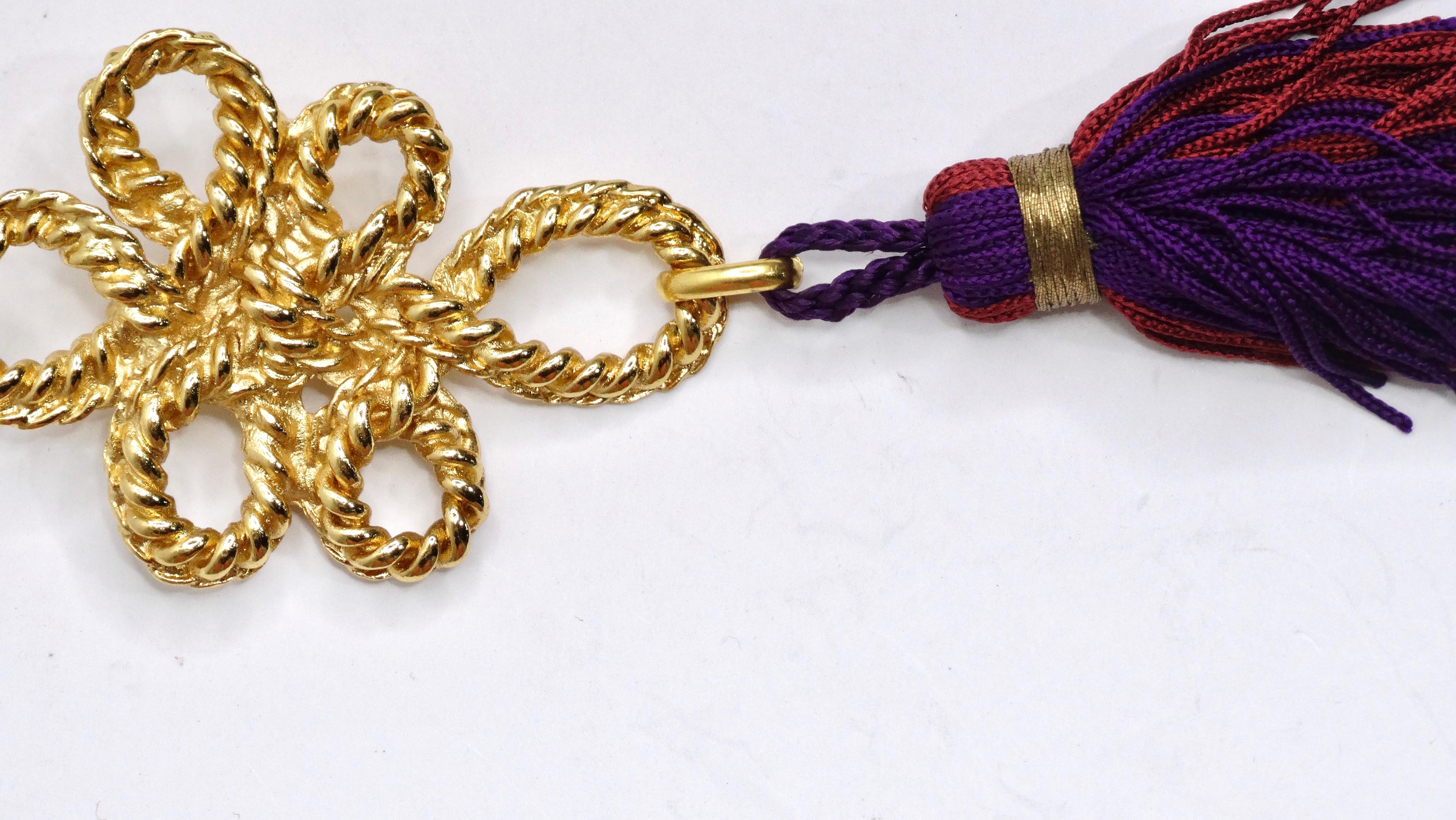 Add a little tassel flair to your brooch collection! Adding movement to your outfit will add a fun and playful  aspect. This is a beautifully unique Yves Saint Laurent brooch with a metal entwined/ knotted rope pendant in a rich and bright gold.