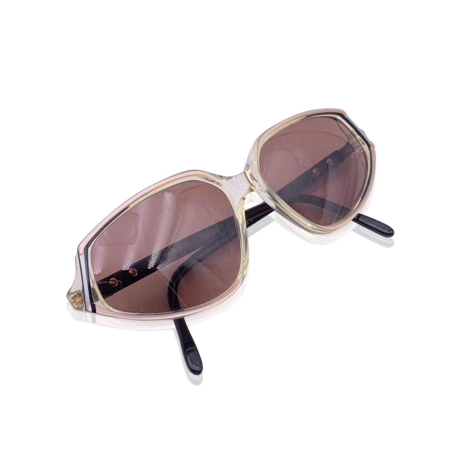 Vintage YVES SAINT LAURENT sunglasses. Mod: NEMESIS - 58/14 - 505. Clear, pink and Black frame cat-eye style frame, with gold metal hardware & YSL logo on the sides. Brown 100% GRADIENT UV lens. Made in France Details MATERIAL: Acetate COLOR: Beige