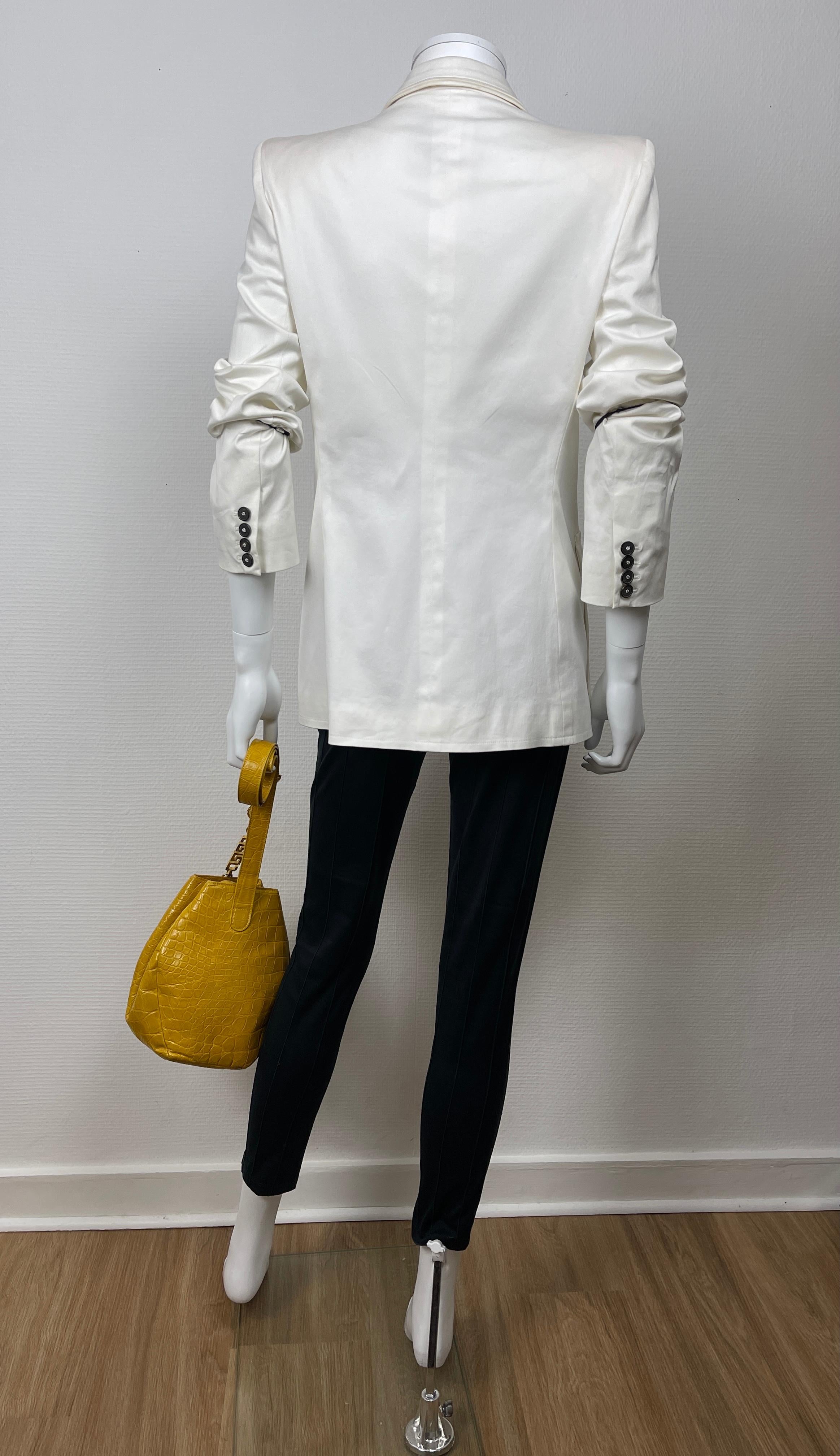 YVES SAINT LAURENT, Made in France, circa 2000’s. 
YSL white cotton jacket with padded shoulders and larges pockets. 
The light on pictures makes it seems shiny but it is not !

Tag size is 42FR but please see measurements bellow, taken flat and