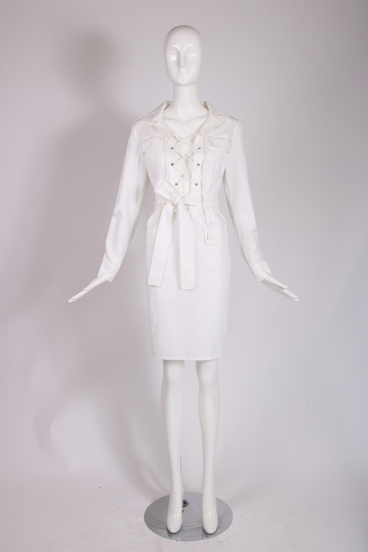 Ca. 2002 YSL by Tom Ford white cotton 'Safari' dress with a lace up front, four frontal pockets and a matching detachable belt. Size tag 36, 100% cotton. In excellent condition.

Shoulders: 16