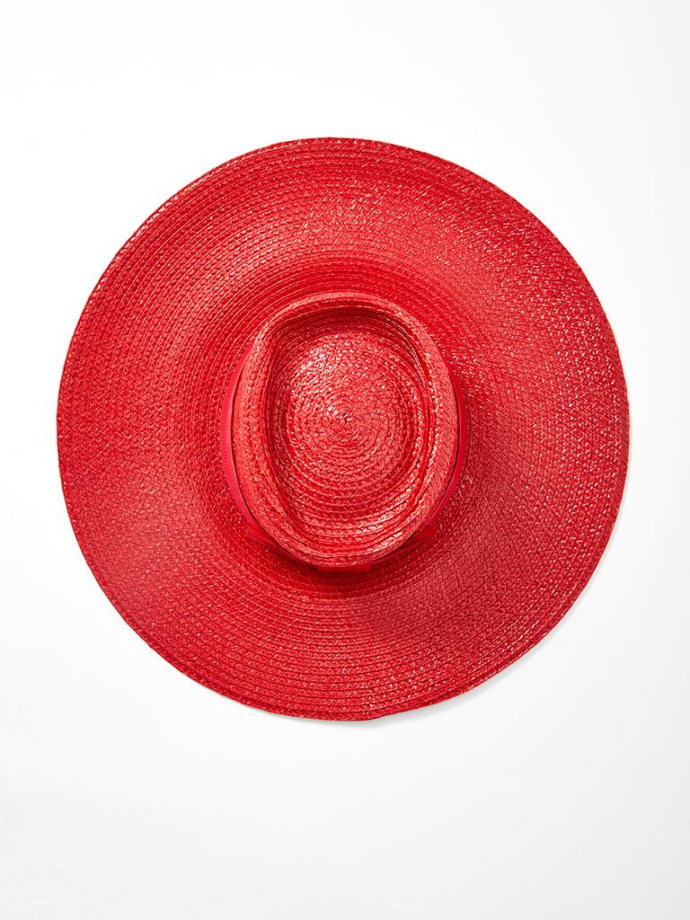 Yves Saint Laurent, wide brim, red lacquered, straw, hat with gross grain ribbon detail at the crown.
Width of brim: 5 inches.