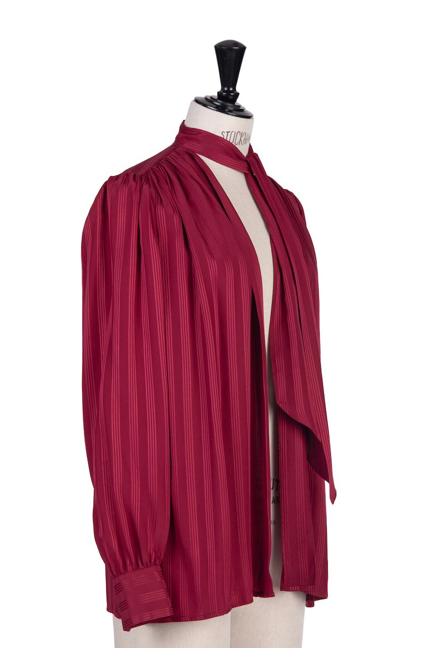 This is a beautiful deep wine red silk blouse by Yves Saint Laurent from the late 1970s or early 1980s with a celebrity bonus. It comes direct from the estate of Hannelore Elsner, an internationally recognized and awarded German actress, who passed