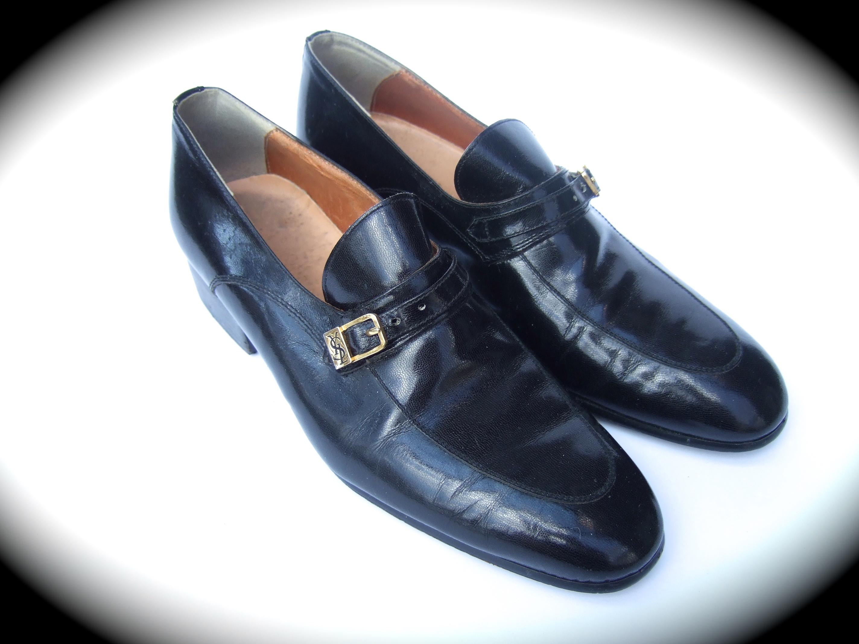 Yves Saint Laurent vintage women's black leather unisex loafers c 1970s
The stylish Italian loafers are constructed with smooth black 
leather. Equivalent to a contemporary US women's size 9  

Adorned with a gilt metal buckle with Saint Laurent's