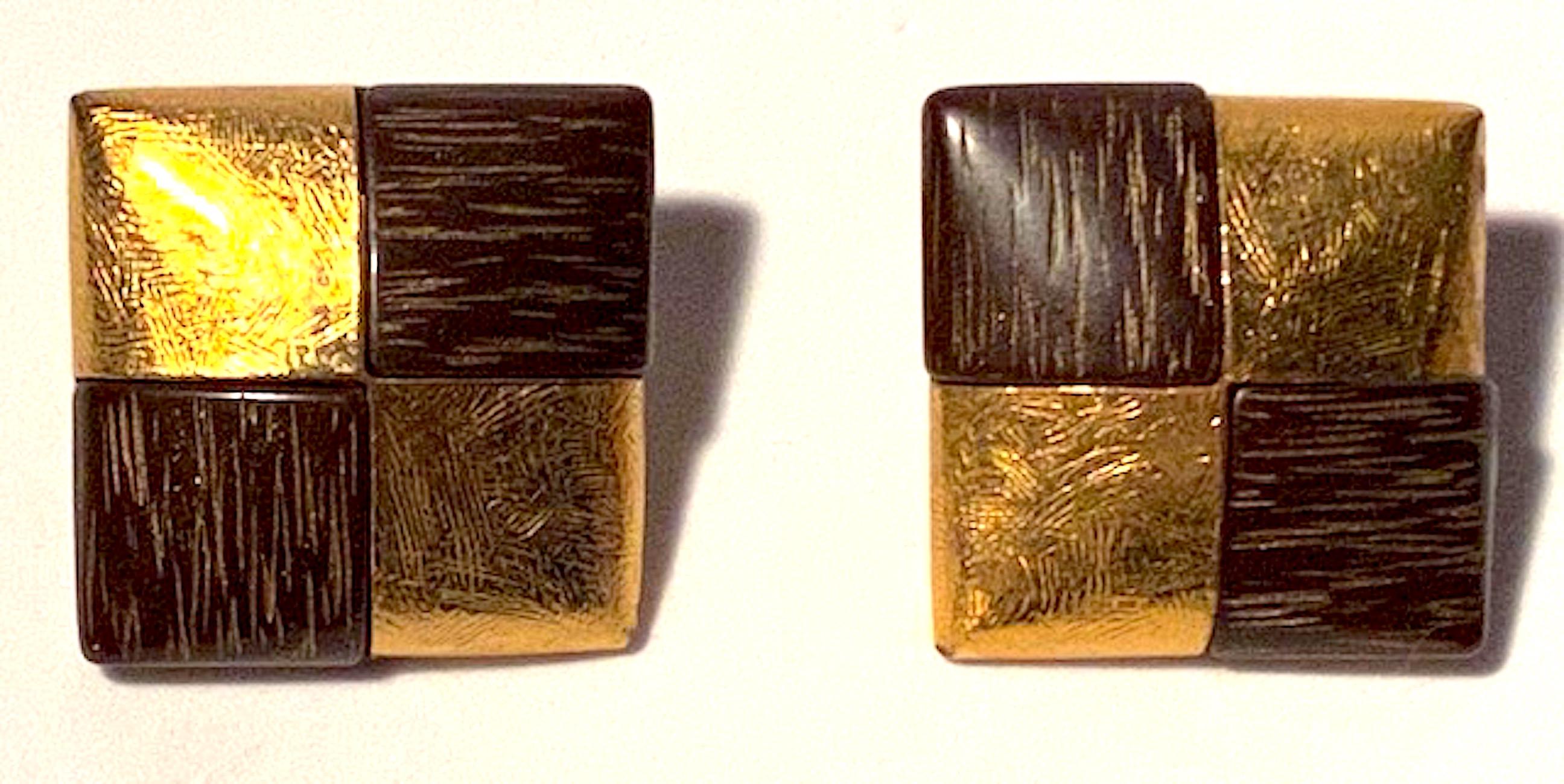 1980s pair of Yves Saint Laurent textured wood tone and gold tone square button earrings. Two. Sating gold plate mount wet with cared faux wood square pieces. Each earring  lightly domed and measures 1 inch square and 1/4 inch high not including the