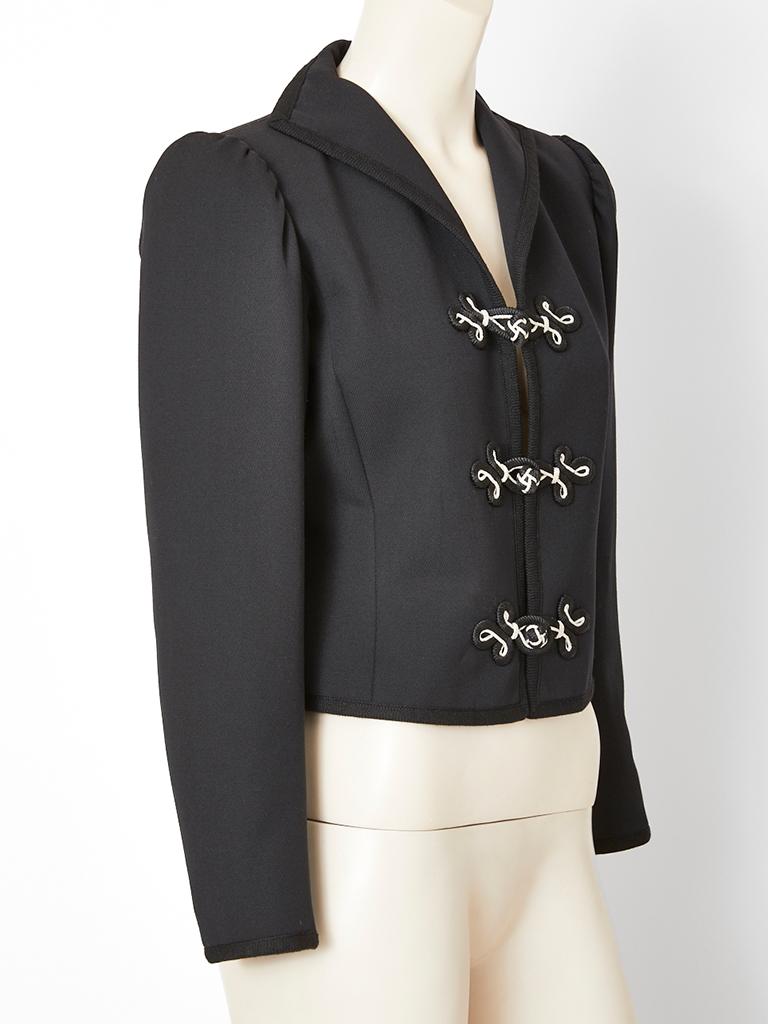 Yves Saint Laurent, Rive Gauche, black, wool gaberdine, fitted,cropped jacket, having a stand up collar, black and white passementerie closures, and black braided trim detail. 