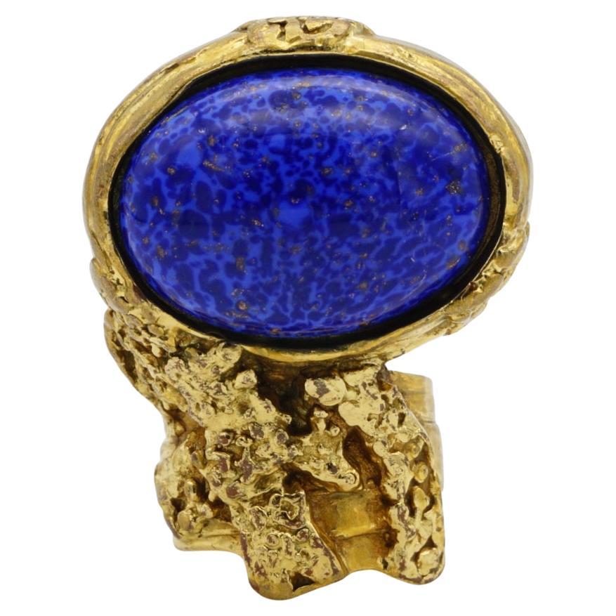 Yves Saint Laurent YSL Arty Vintage Unisex Blue Navy Lapis Statement Chunky Cabochon Cocktail Ring, Size 5, Gold Tone

Very good condition on front side. Colour loss on back of band, especially inside. Vintage. 100% genuine. 

Signed on the back