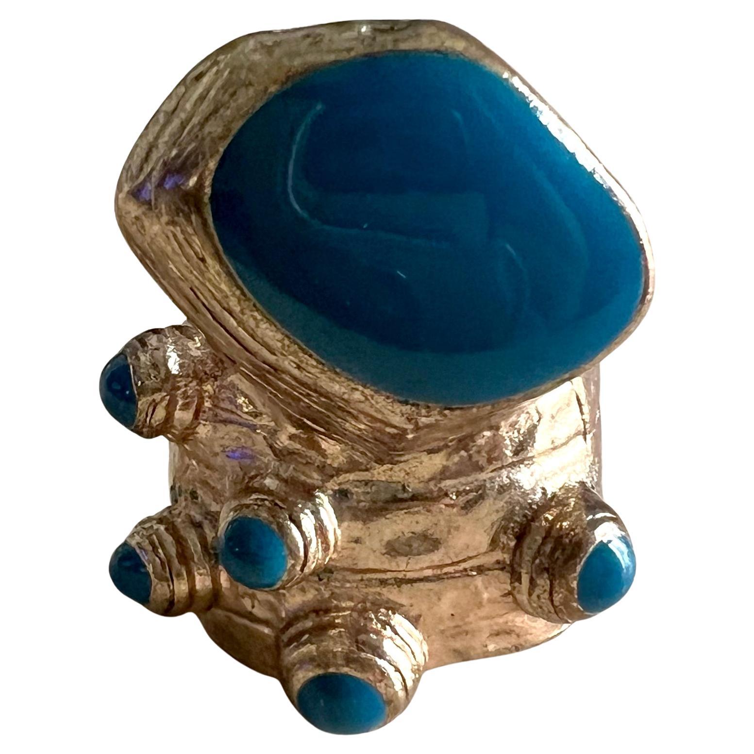 Vintage Yves Saint Laurent gold tone ring with teal enamel stone decoration, circa 2000.  Ring is a size 7.25. Signed on the back of the shank, Yves Saint Laurent.  In very good vintage condition.  