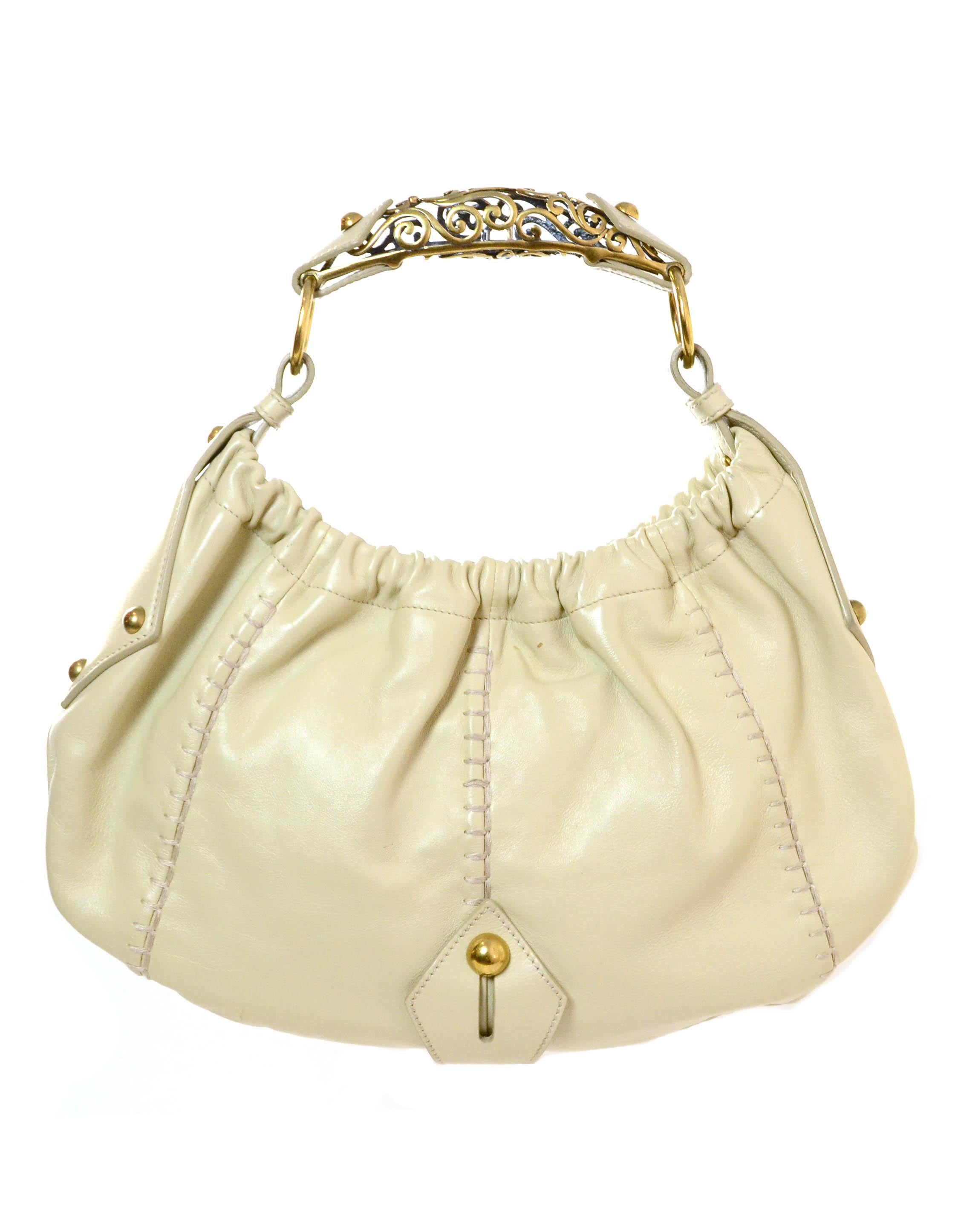Yves Saint Laurent Beige Leather Vincennes Mombasa

Made In:
Year of Production: 2005
Color: Beige
Hardware: Antiqued goldtone
Materials: Leather and metal
Lining: Fine textile
Closure/Opening: Center magnetic snap
Exterior Pockets: None
Interior