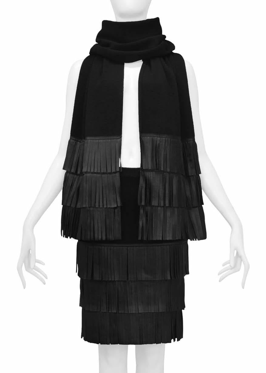 Resurrection Vintage is excited to offer a vintage YSL black knit skirt and scarf ensemble featuring a soft wool ribbed knit fabric, leather fringe, elastic waistband, and knee-length.

Yves Saint Laurent
Rive Gauche
Skirt: 36
Scarf: One Size
Wool &