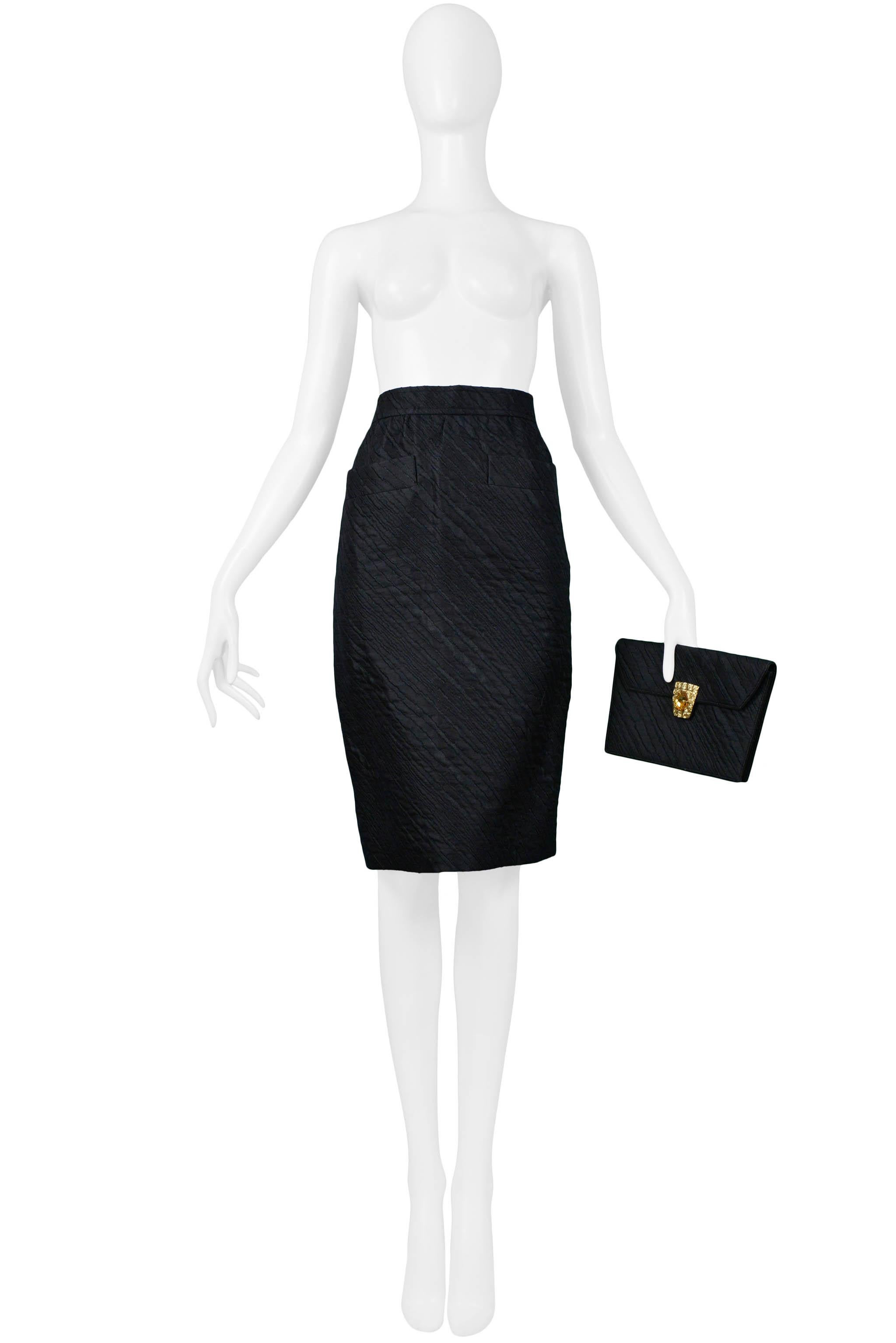 Resurrection Vintage is excited to offer a vintage Yves Saint Laurent black jacquard pencil skirt with slit pockets at front and a matching evening clutch with yellow stone and embossed gold-tone hardware closure.

Yves Saint Laurent
Size
