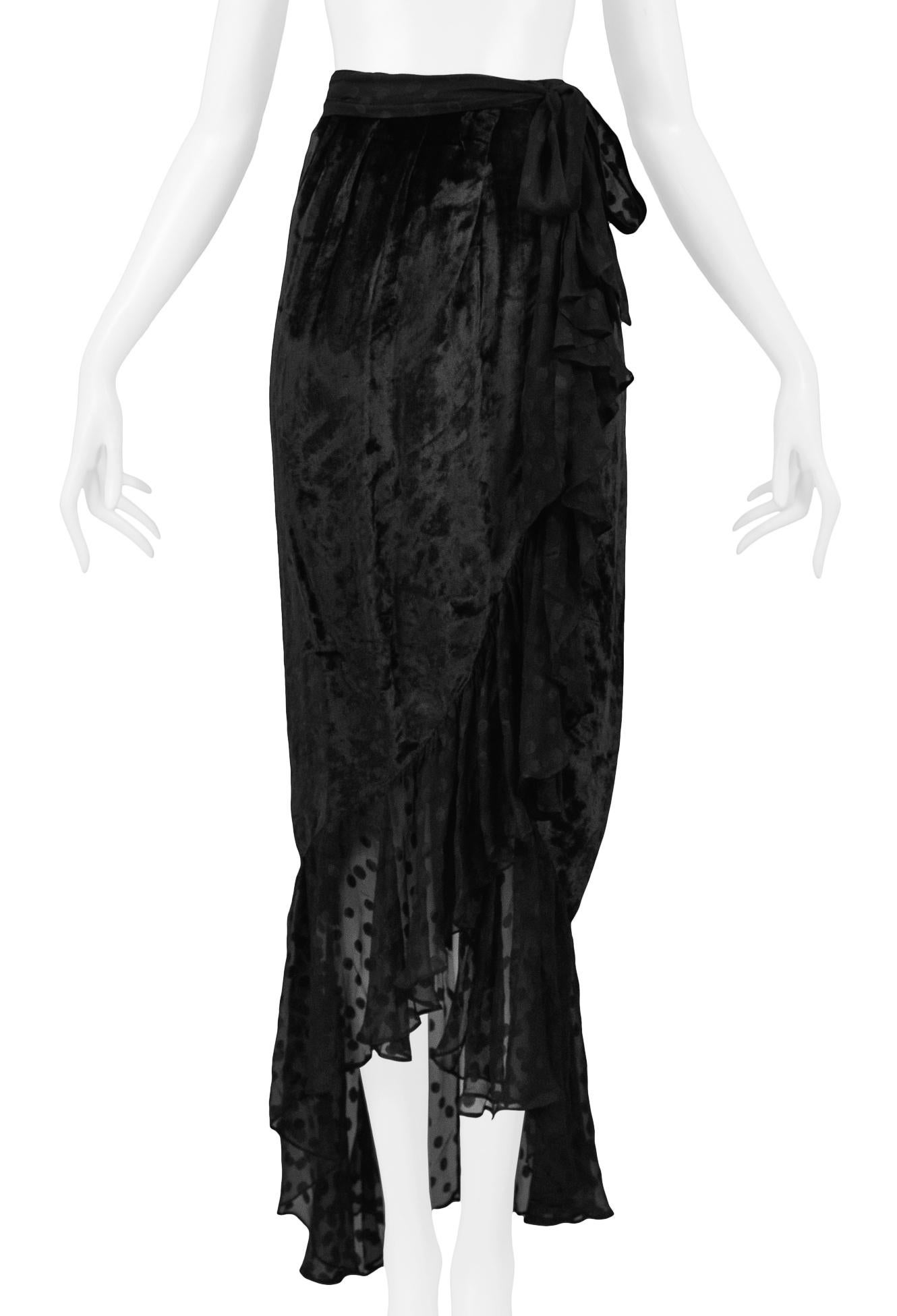 Resurrection Vintage is excited to offer a vintage Yves Saint Laurent black silk chiffon and velvet ruffle evening skirt featuring a high waist, wrap front with exposed slit, dot print chiffon ruffles, hook and eye closure, and tie belt. 

Yves