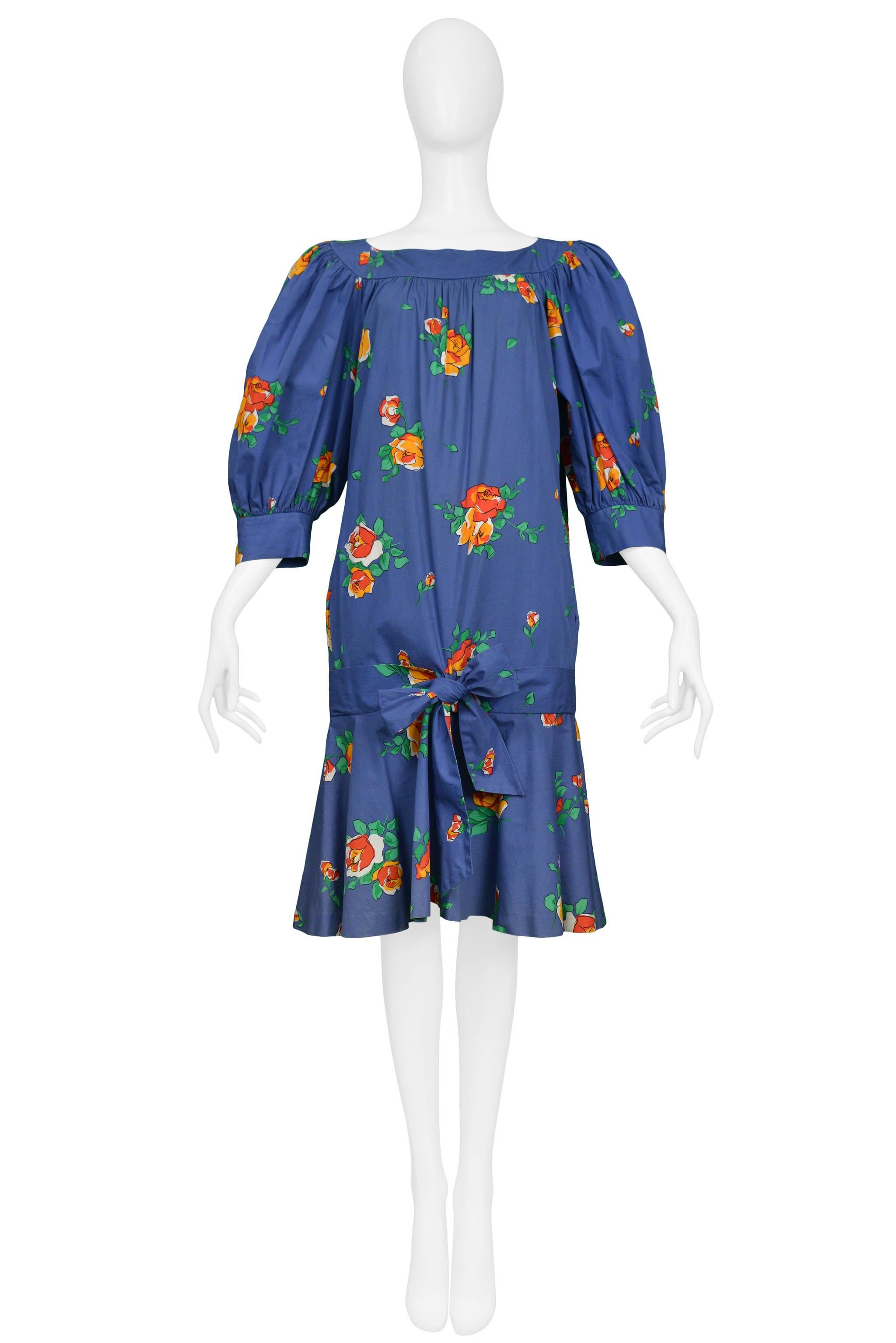 Resurrection Vintage is excited to offer a vintage floral Yves Saint Laurent blue cotton smock dress with a drop waist and knit tie front. The dress features a boat neck, blouson sleeves, and knee-length.

Yves Saint Laurent
Size