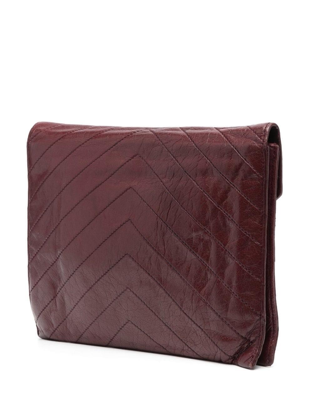 Yves Saint Laurent YSL bordeaux calf leather quilted clutch bag featuring a chevron-quilted pattern, an envelope design, foldover top with magnetic fastening, a zip-fastening compartment, a cotton logo monogram lining, an internal logo stamp.
Circa