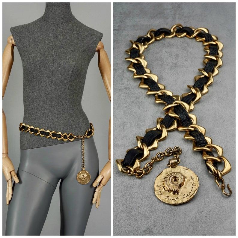 Vintage YVES SAINT LAURENT Ysl by Robert Goossens Chain Leather Fossil Medallion Necklace Belt

Measurements:
Length: 36 inches (91.44 cm)
Height: 1 2/8 inches (3.17 cm)
Medallion: 2 inches X 2 inches (5 cm X 5 cm)

Features:
- 100% authentic YVES