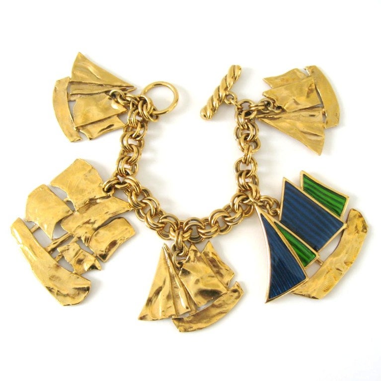 Yves Saint Laurent Sailboat charm bracelet. Large Charms and 1 has vibrant enamel blues and greens on the sails. Measures approximately 7.5 in. end to end.. Largest Charm 2 in x 2.5 inches. This is out of our massive collection of Hopi, Zuni,