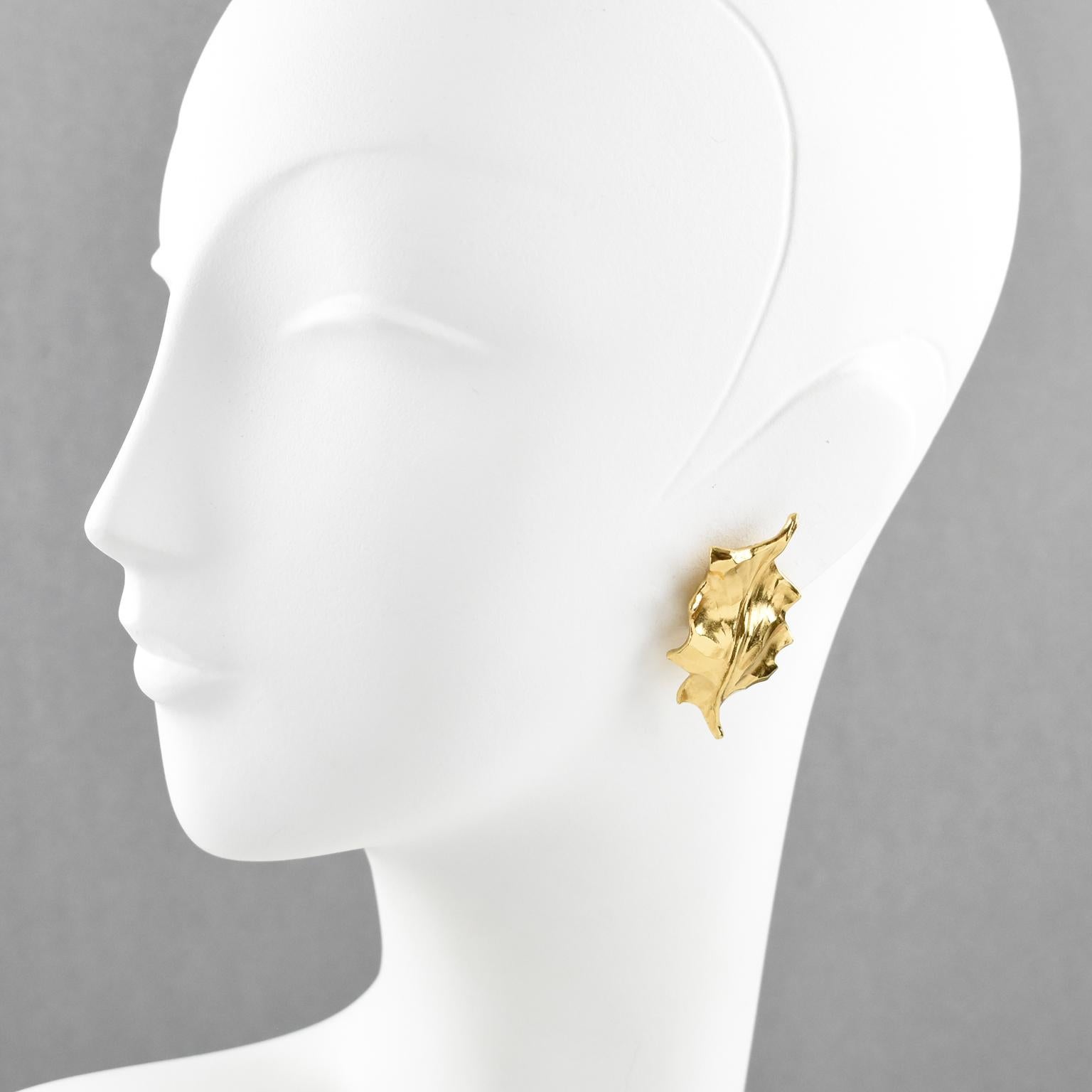 Elegant Yves Saint Laurent YSL Paris Leaf clip-on earrings. Featuring gilt metal bold floral shape with a holly leaf, metal all textured with dimensional carved design. Signed at the back 