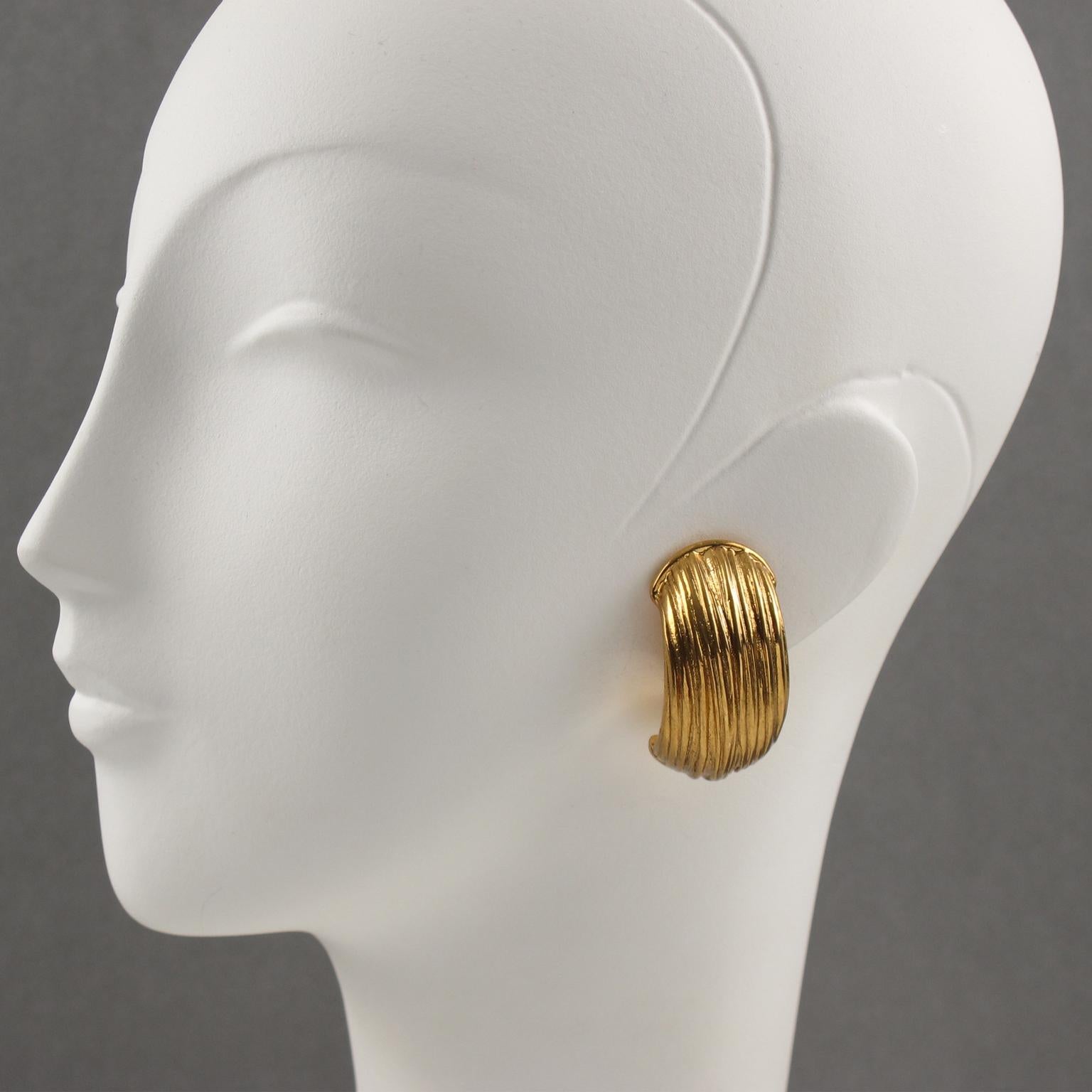 Lovely Yves Saint Laurent YSL Paris signed clip-on earrings. Features a dimensional hoop shape with gilt metal all carved and textured. Signed with 