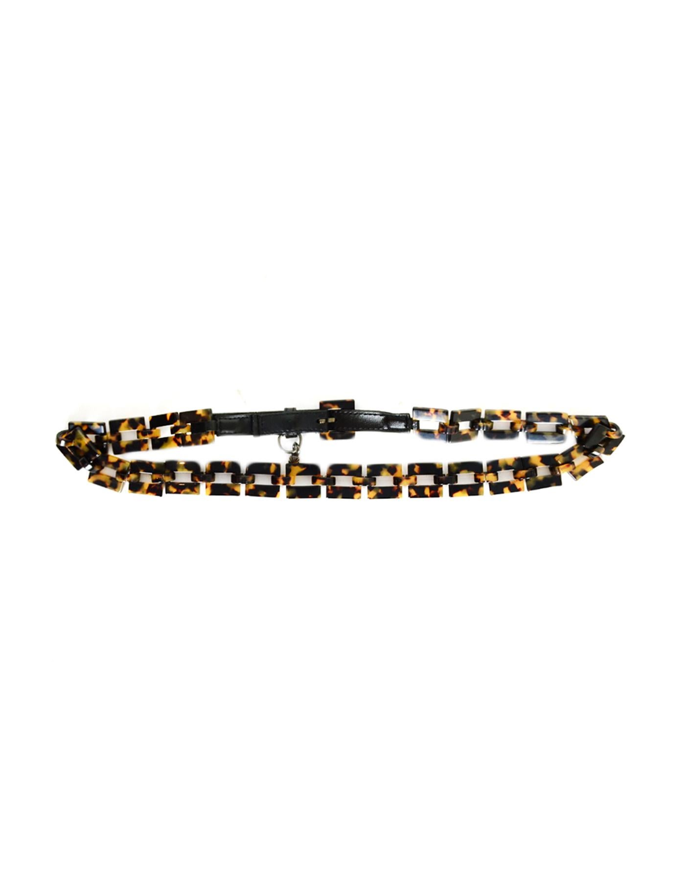 Yves Saint Laurent YSL Faux Tortoiseshell & Leather Belt.  Features YSL small charm hanging from belt loop.

Made In: France
Color: Brown/beige/tan & black
Hardware: Darkened silvertone
Materials: Resin (faux tortoiseshell) and