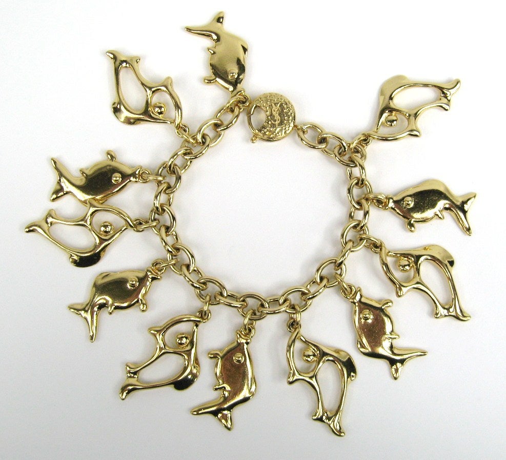 Stunning YSL Yves Saint Laurent Fish Charm Bracelet that was never worn. Charms hang down 1.68 Inches. Will fit a 6 inch wrist nicely. This is out of our massive collection of Hopi, Zuni, Navajo, Southwestern, sterling silver, costume jewelry and