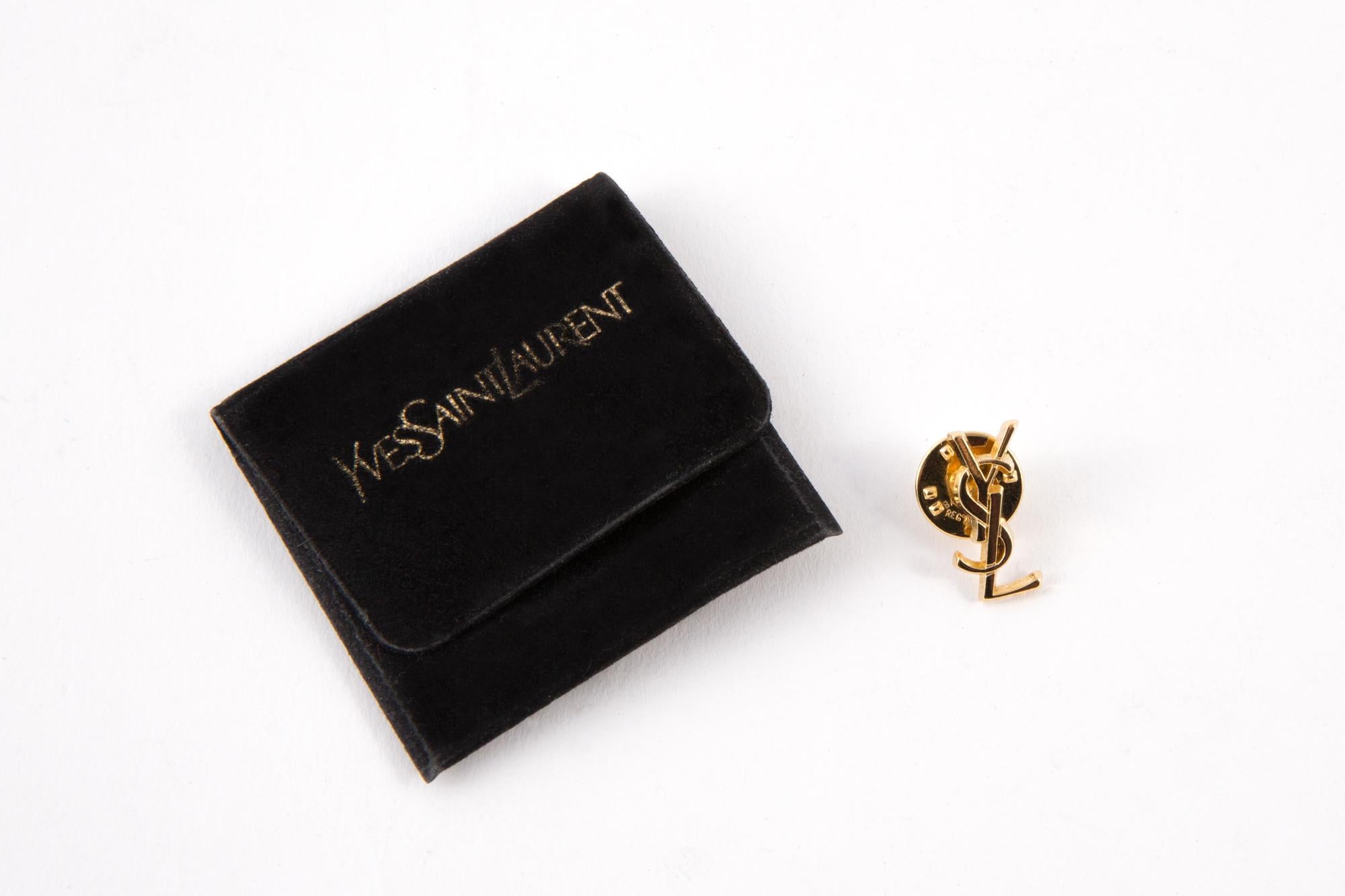  1990s Yves Saint Laurent gold-tone pin brooch featuring a decorative YSL,  a back pin. 
 Maxi length: 1.18in. (3cm)
In good vintage condition  Made in France. 
We guarantee you will receive this gorgeous item as described and showed on photos.
