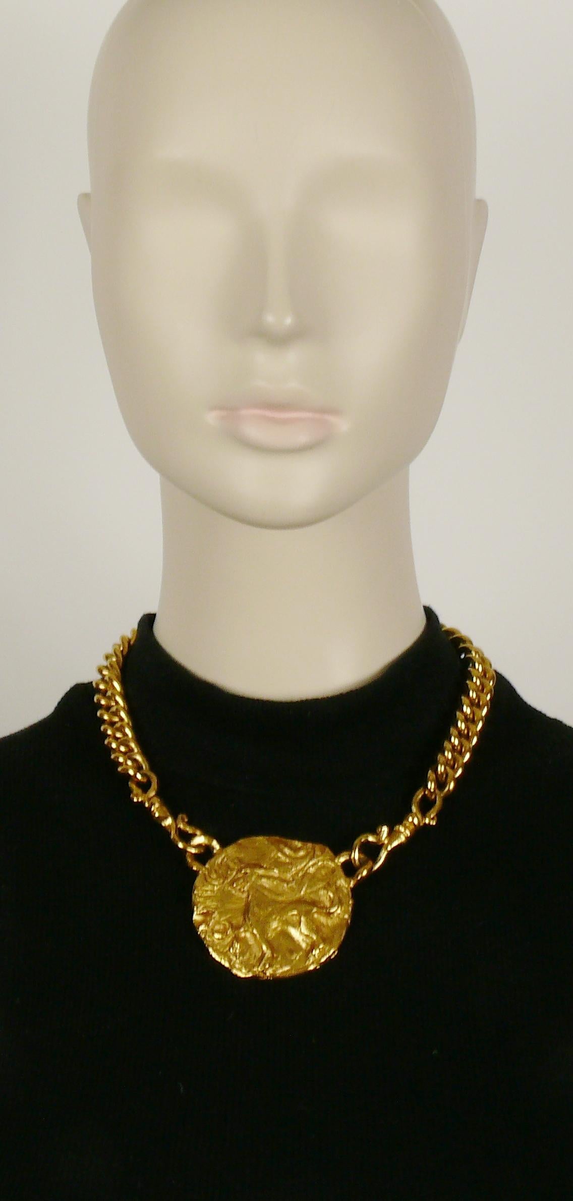 YVES SAINT LAURENT vintage gold toned chunky chain necklace featuring a raised and textured mythological creature medallion.

Toggle and hearts closure with YVES SAINT LAURENT signatures.
Adjustable length.

Embossed YVES SAINT LAURENT on the heart