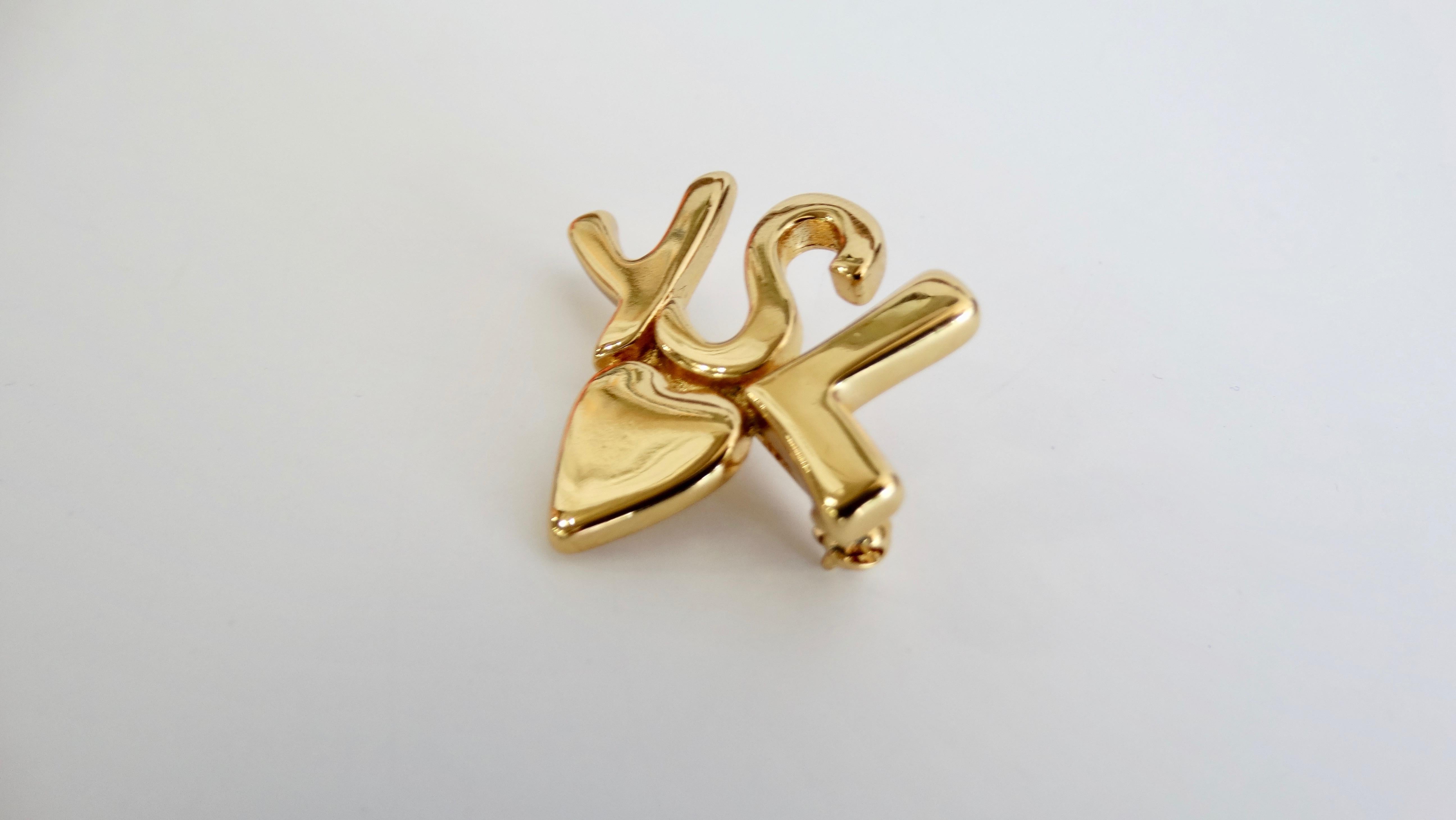 No one does eye candy like Yves Saint Laurent! Circa 1980s, this gold plated pin features the iconic 