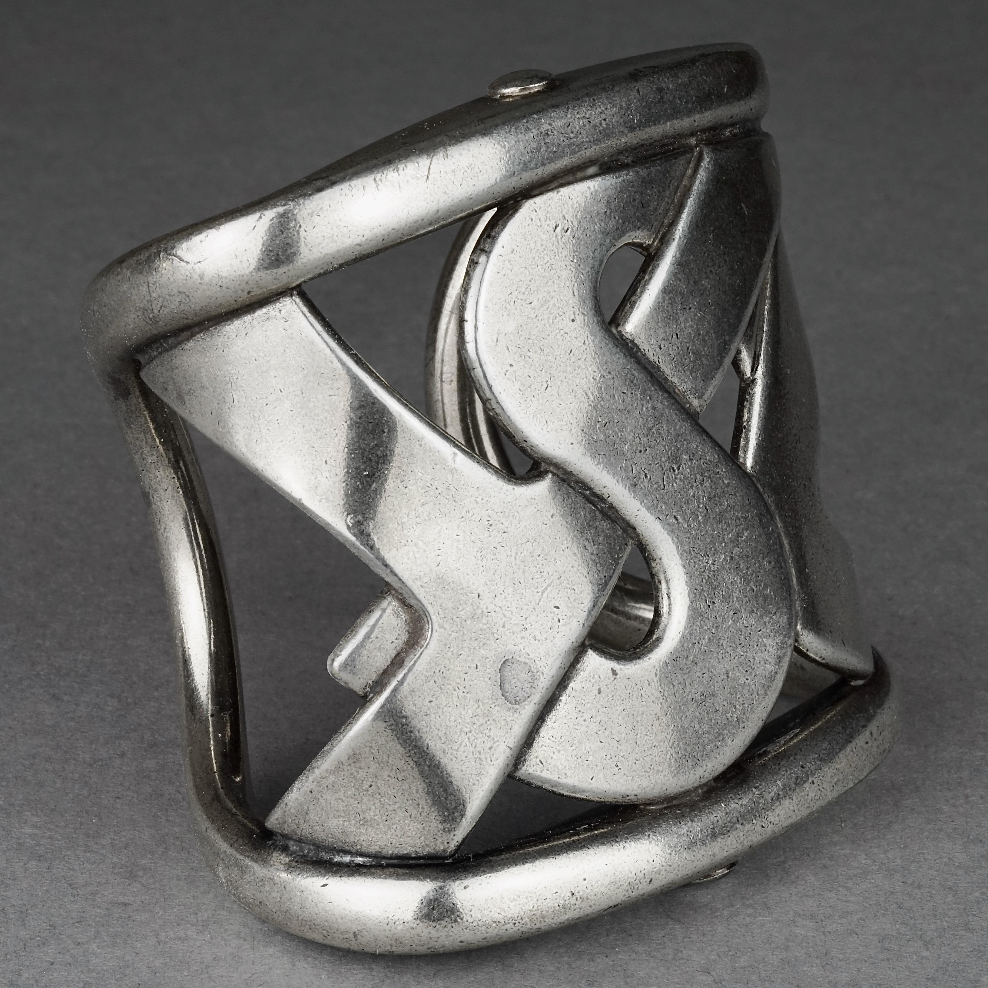 Yves Saint Laurent YSL Logo Wide Silver Cuff Bracelet

Measurements:
Height: 2.95 inches (7.5 cm)
Inside Circumference: 6.50 inches (16.5 cm) 

Features:
- 100% Authentic YVES SAINT LAURENT.
- YSL logo silver cuff.
- Signed YVES SAINT LAURENT Rive