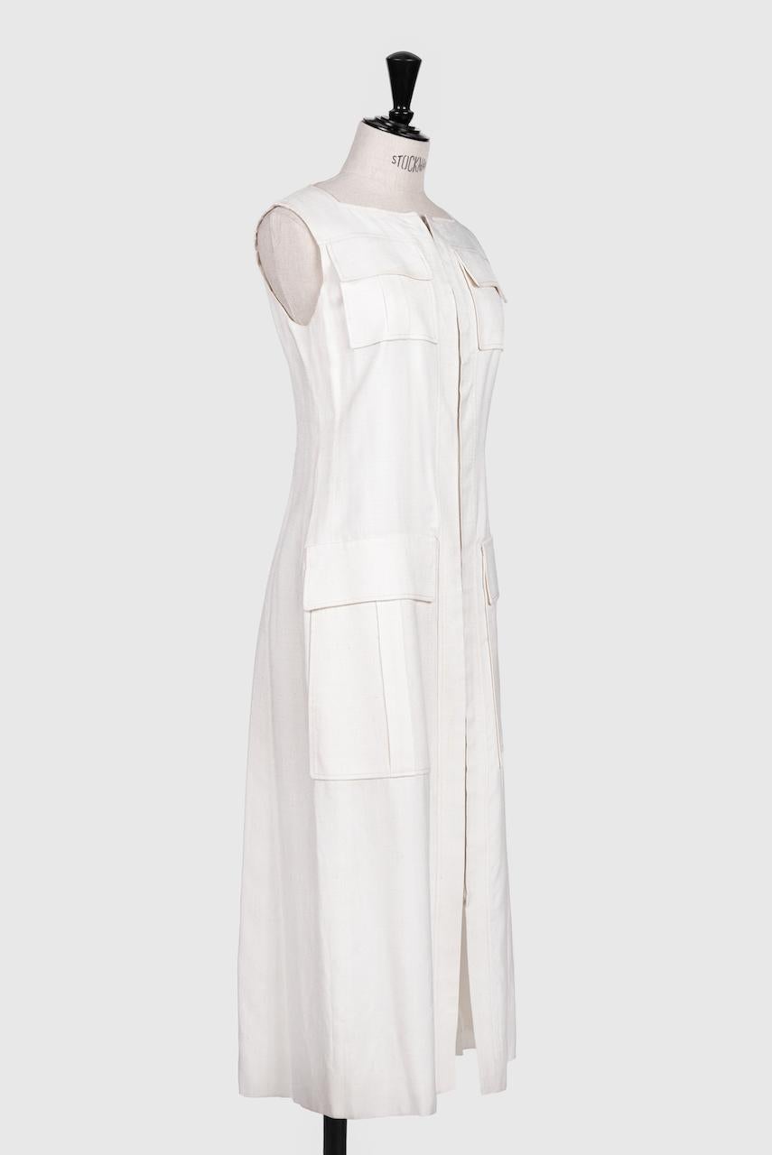 Rare Ted Lapidust Paris late 1960s/early 1970s off-white maxi vest or dress with four dramatic top set faux flap pockets that work as slit pockets. The fabulous sleeveless design is made of a high quality silk linen mix and features a square neck