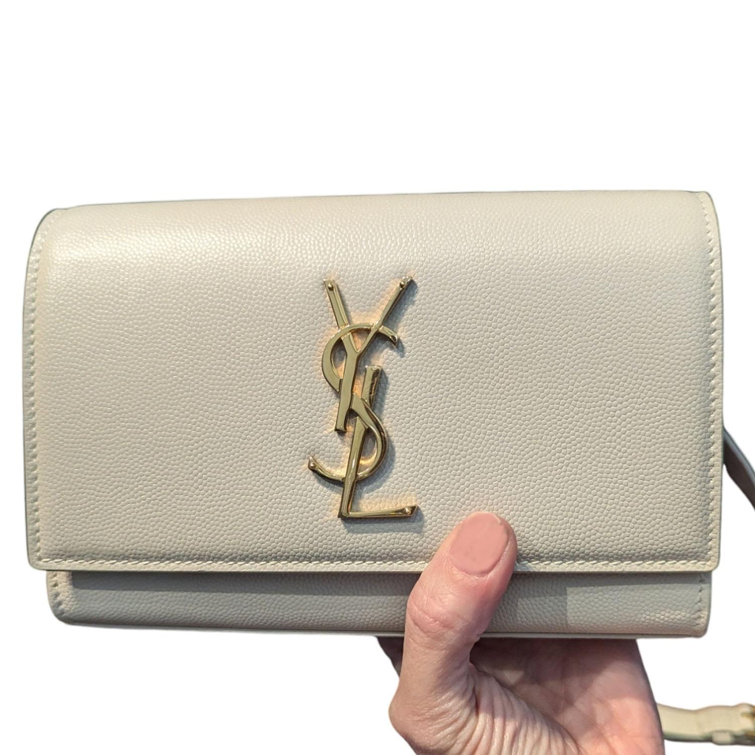 Effortlessly elevate your style with the YSL Yves Saint Laurent Kate Belt Bag. Made in Italy with a luxurious grain de poudre leather exterior and gold-tone hardware, it features a flap closure with magnetic snap for easy access. The interior boasts