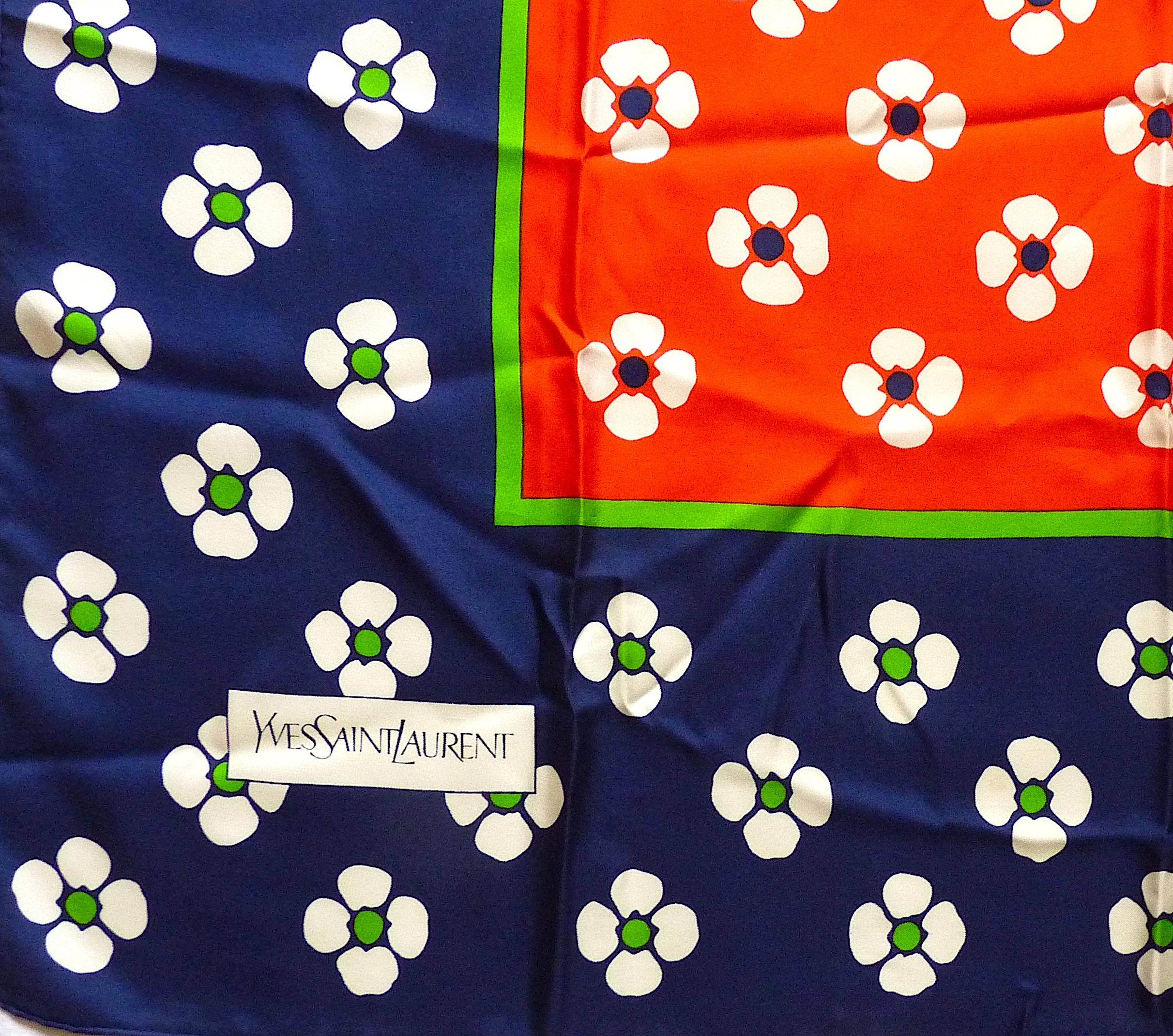 This is a YVES SAINT LAURENT Pop Flower Silk Scarf,  Vintage YSL from the 1970s, very 70's with its stylized flowers, in very good condition.

Colourways typically from the 70's : Navy, Bright Red, Apple Green

Signed YVES SAINT LAURENT at the