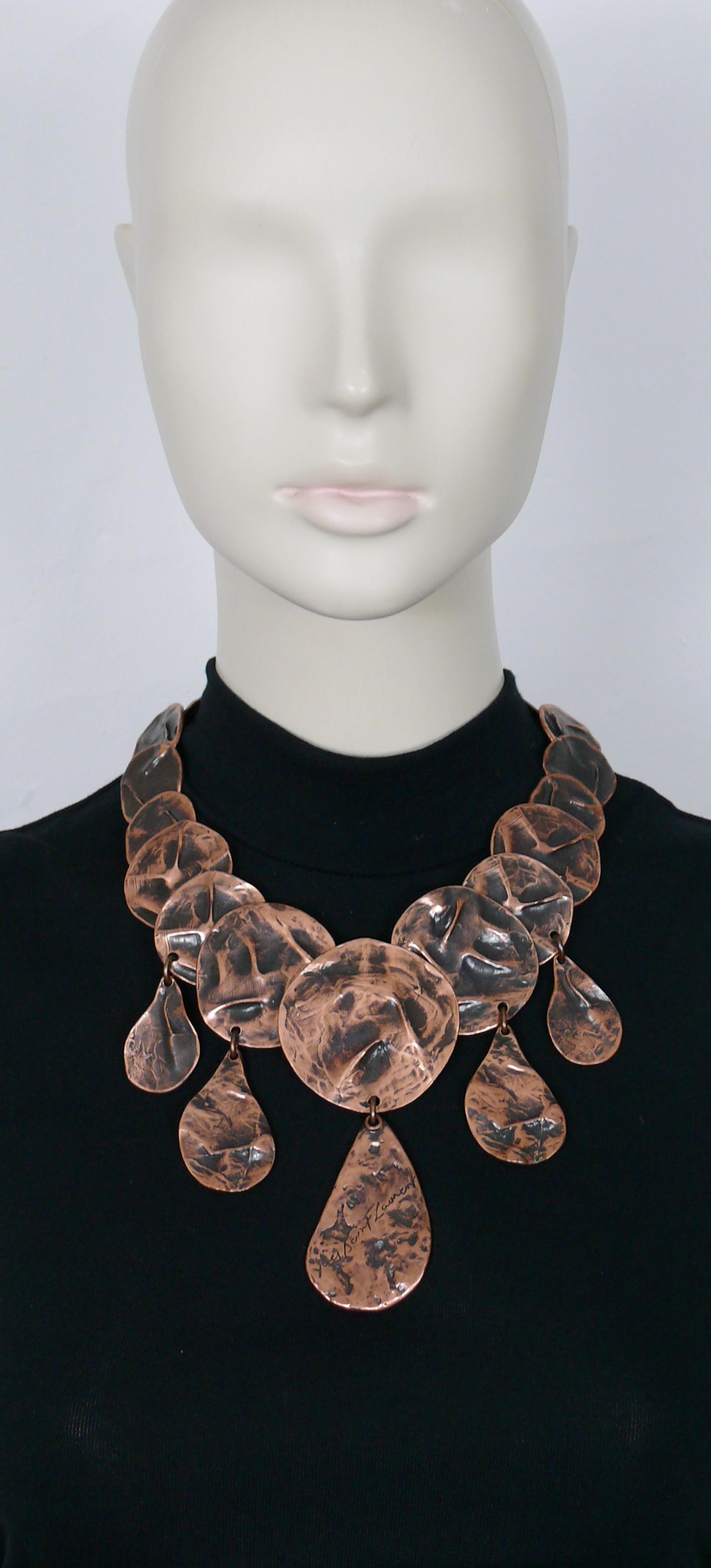 YVES SAINT LAURENT vintage rare opulent copper toned articulated necklace featuring crumpled disc links and drops with the central drop embossed with YVES SAINT LAURENT cursive signature.

Adjustable lobster spring closure.
Extension chain and clasp