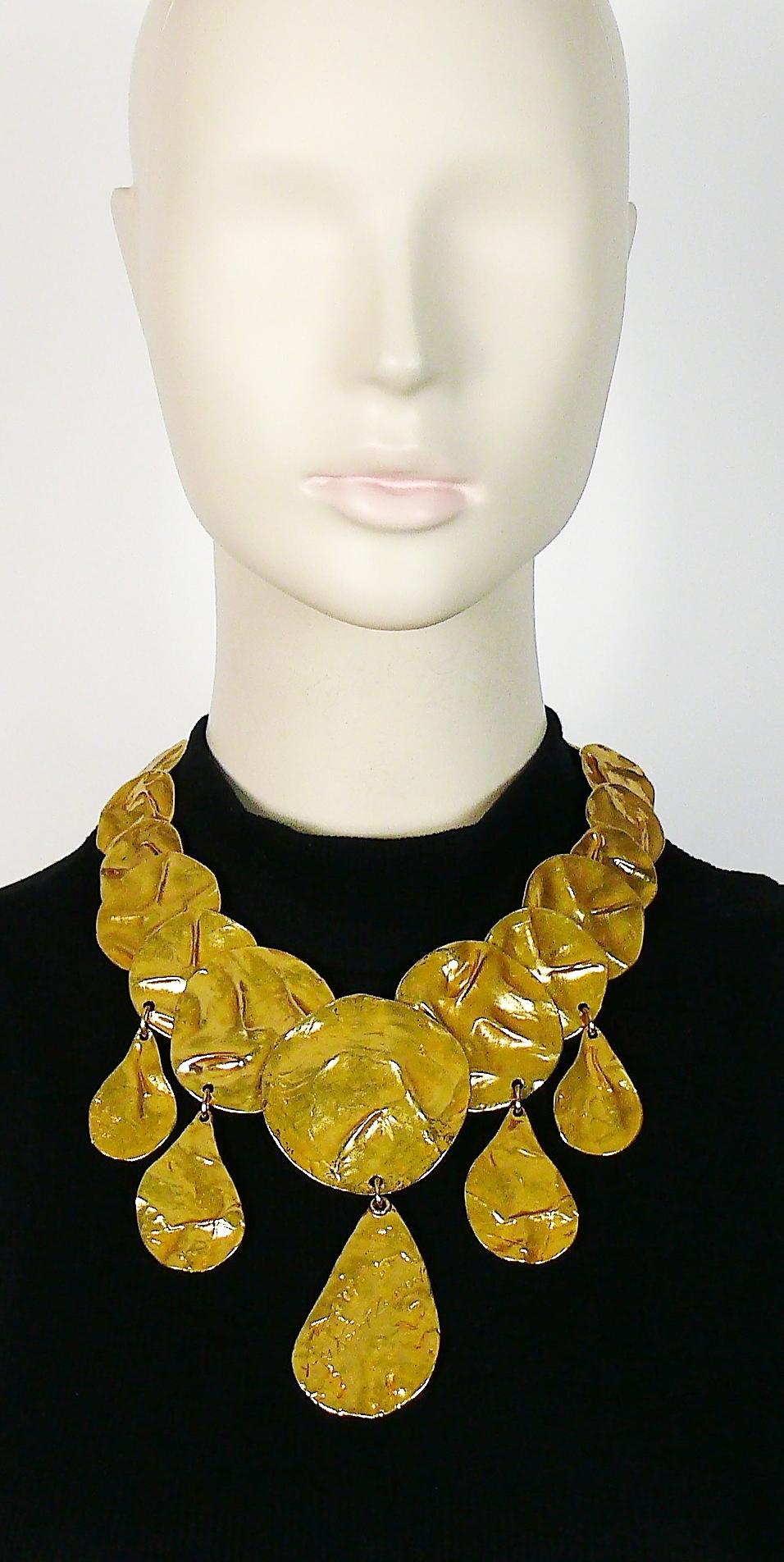 Vintage By By, rare collier articulé en or opulent, composé de maillons et de gouttes en forme de disques froissés, avec une goutte centrale gravée YVES SAINT LAURENT.

Fermeture réglable à ressort de type homard.

YSL Made in France embossé sur le