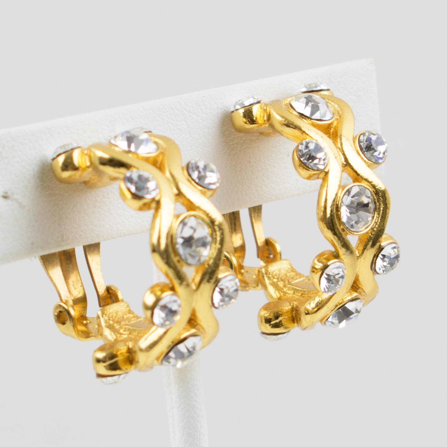 These adorable Yves Saint Laurent YSL Paris clip-on earrings feature a dimensional half-hoop shape with shiny gilt metal all carved and ornate with clear crystal rhinestones. The 