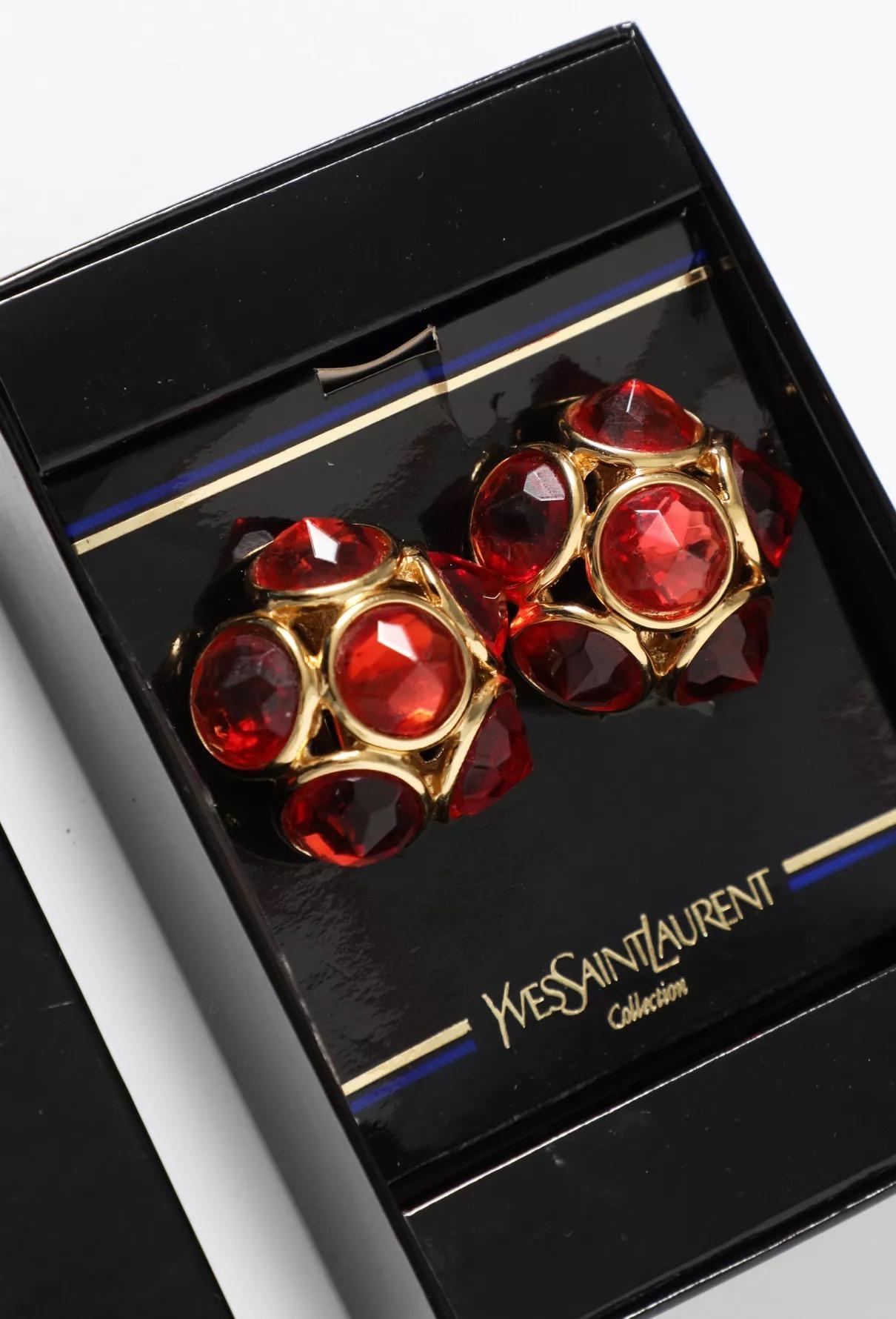 Yves Saint Laurent YSL pyramid glass stones clip on earrings featuring deep orange lacquered glass stones, a clip-on fastening, a back pitted plaque. 
Comes with original box  
Made in France, pitted logo YSL on clip.
Circa 1990s. 
They come as a