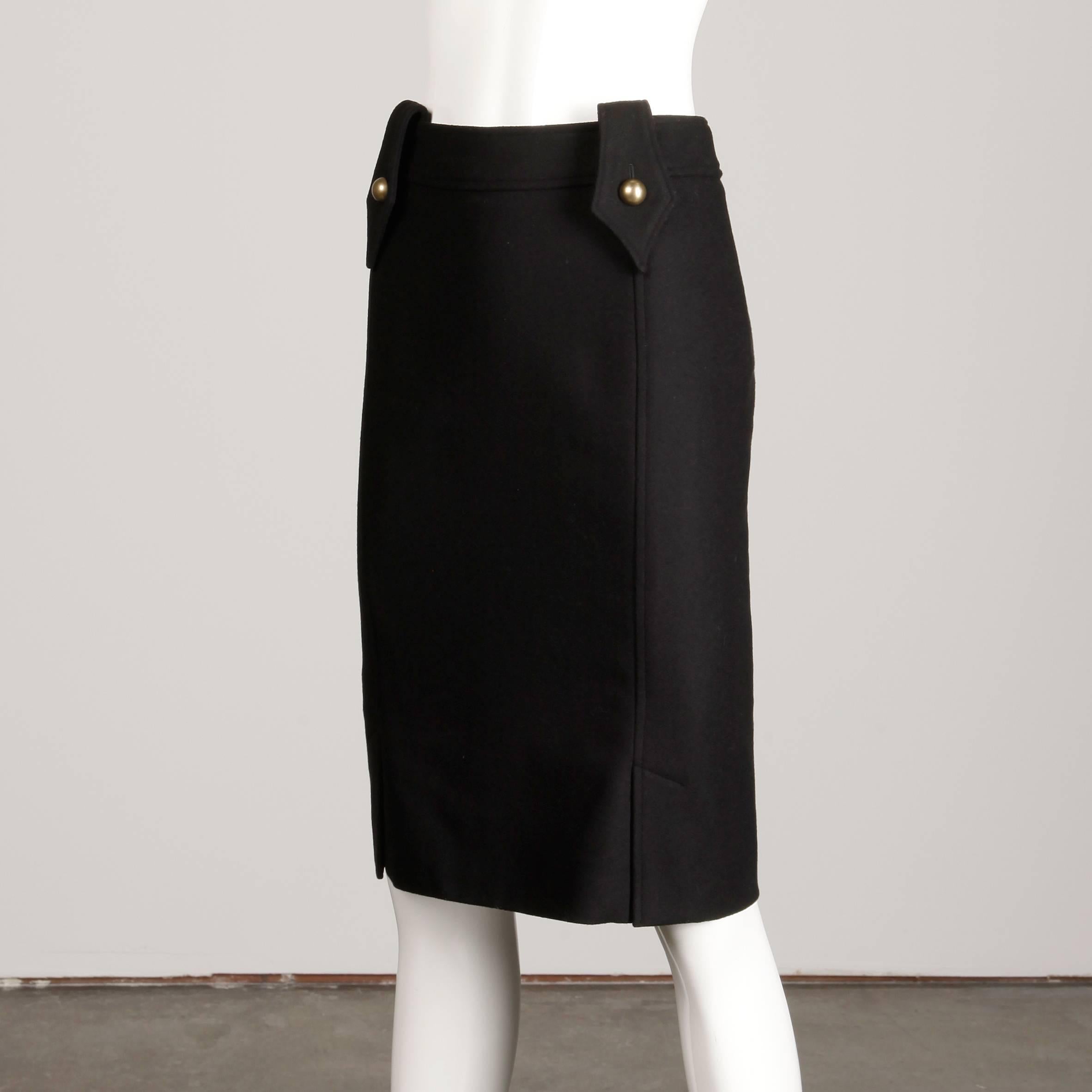 Simple and chic pencil skirt by Yves Saint Laurent in black wool. Fully lined with rear zip and hook closure. 97% wool, 3% spandex. The marked size is 36/ US4. The low waist measures 29.5