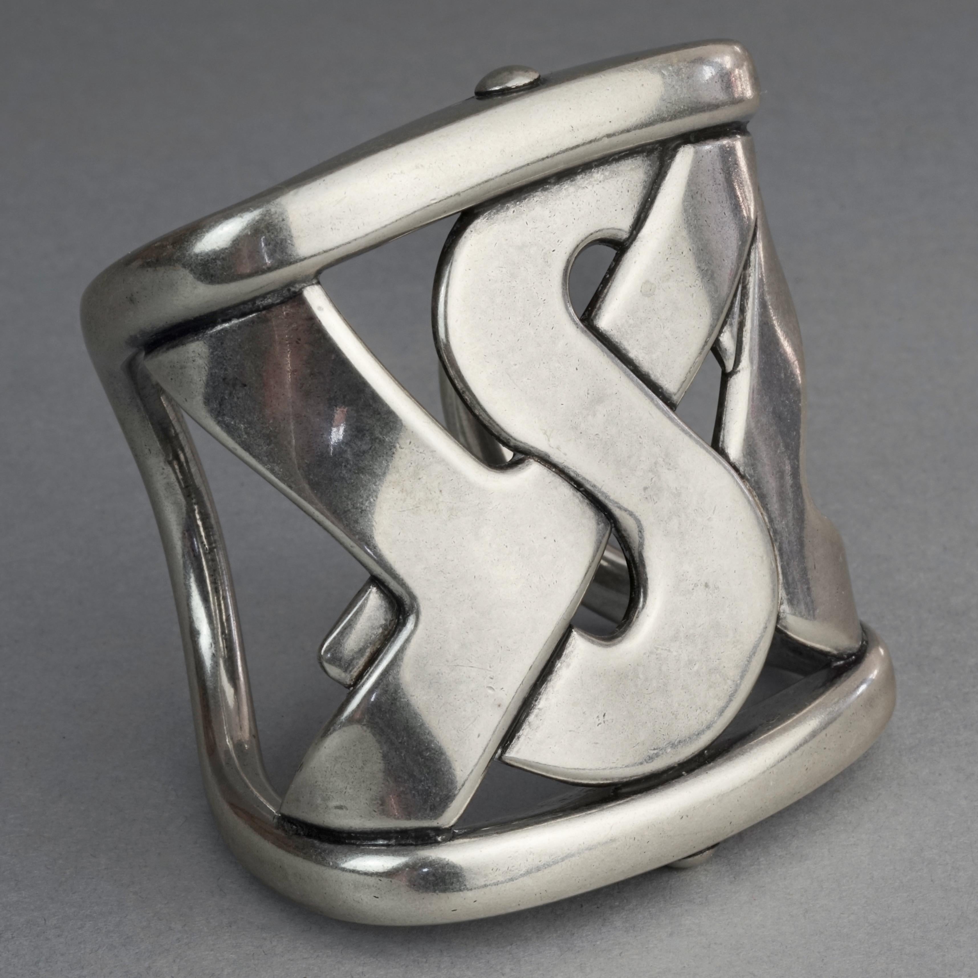 YVES SAINT LAURENT Ysl Rive Gauche Logo Silver Cuff Bracelet

Measurements:
Height: 2.95 inches (7.5 cm)
Inside Circumference: 6.88 inches (17.5 cm) includes opening

Features:
- 100% Authentic YVES SAINT LAURENT.
- YSL logo silver cuff.
- Signed