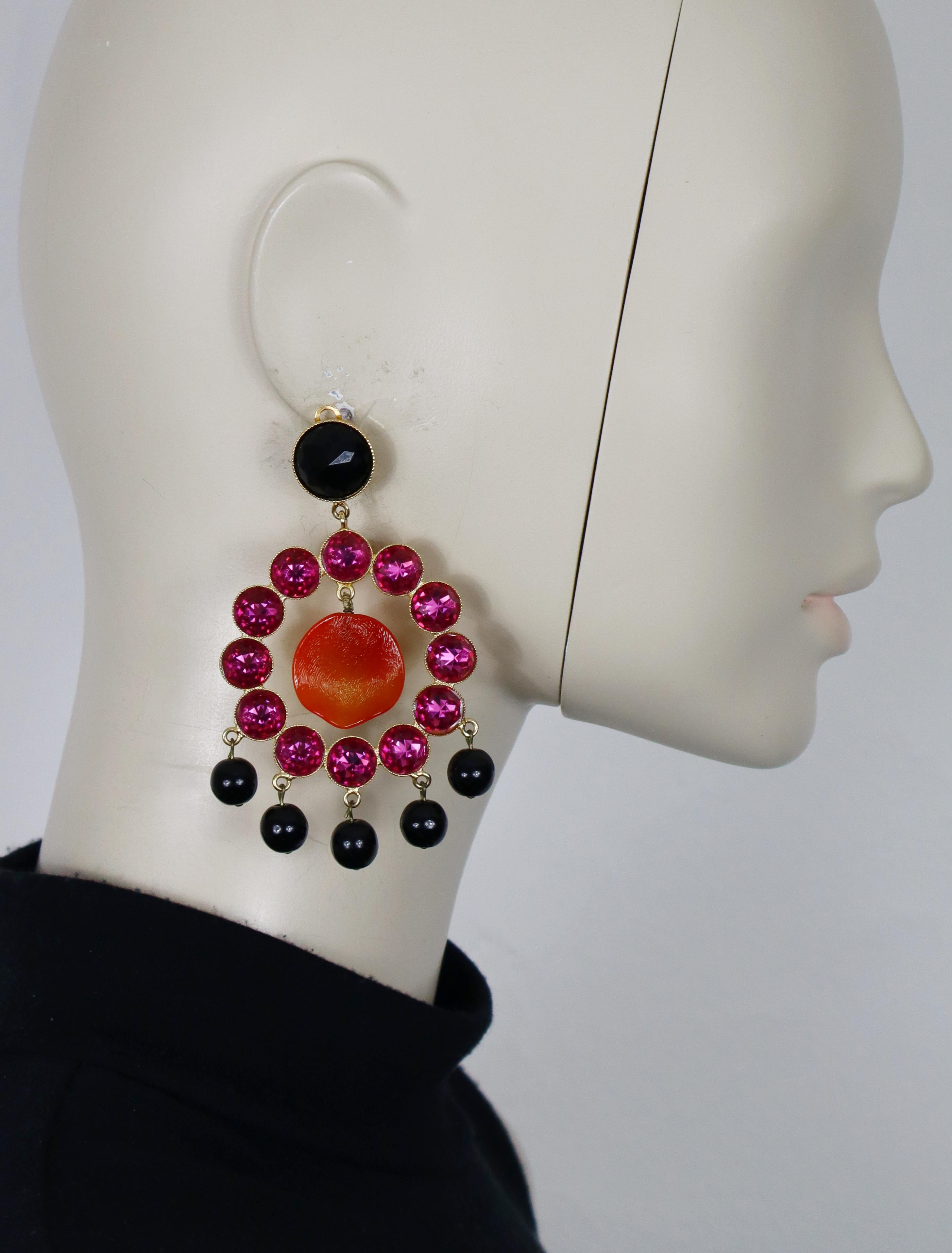 YVES SAINT LAURENT vintage massive gold tone dangling earrings (clip-on) embellished with multicolored crystals, black glass beads and a creased resin petal at the center.

Embossed YVES SAINT LAURENT Rive Gauche (only on one earring).
Gold stickers