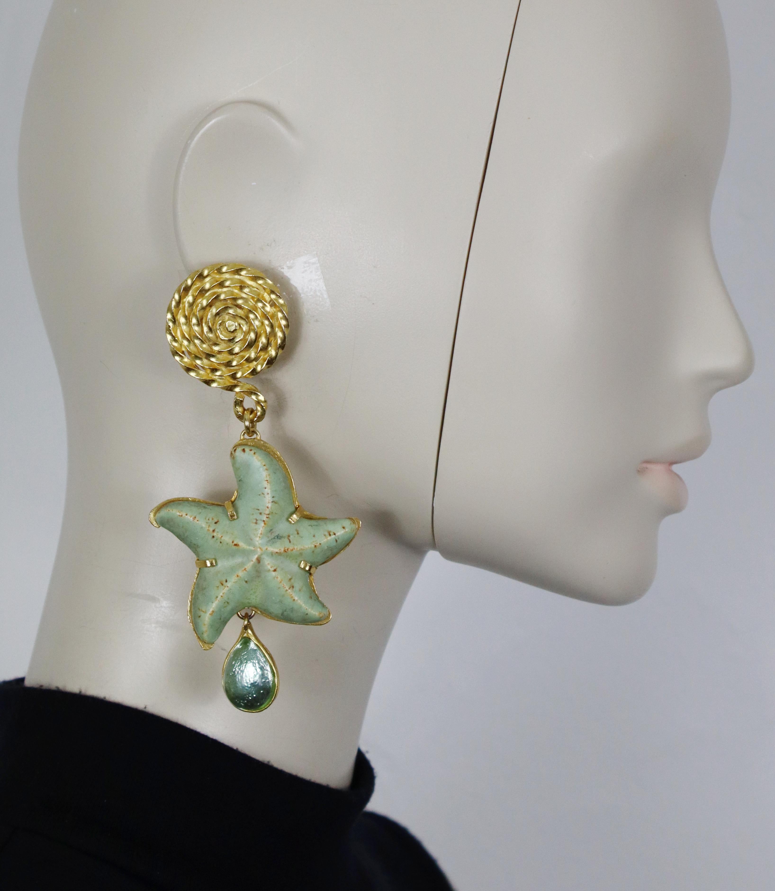YVES SAINT LAURENT vintage massive gold tone dangling earrings (clip-on) featuring a ceramic starfish and a glass cabochon drop.

Embossed YVES SAINT LAURENT Rive Gauche.
Made in France.

Indicative measurements : height approx. 11 cm (4.33 inches)