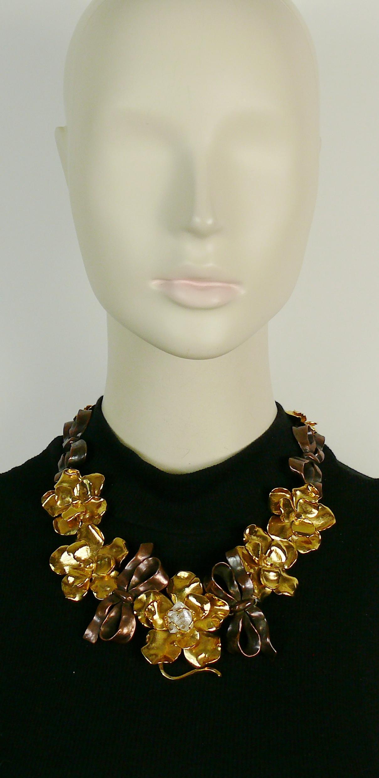 YVES SAINT LAURENT vintage rare two toned necklace featuring three-dimensional gold toned flowers and antiqued copper toned bow of various sizes. The central flower is embellished with an encaged rock crystal prism center.

Adjustable hook clasp