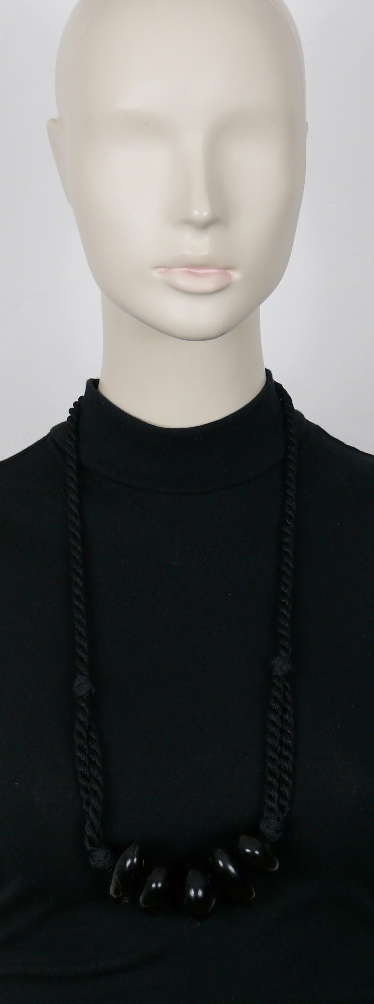 YVES SAINT LAURENT black rope tassel necklace featuring five chunky black marbled resin pebbles.

Embossed YVES SAINT LAURENT Rive Gauche.
Made in France.

Indicative measurements : length worn approx. 35 cm (13.78 inches).

Material : Passementerie