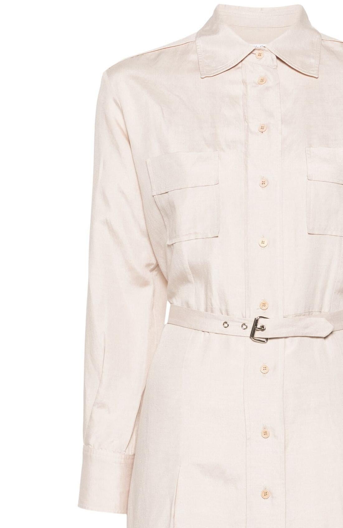 Yves Saint Laurent YSL light beige silk shirt dress featuring a pleat detailing, straight-point collar, front button fastening, long sleeves, buttoned cuffs, two chest flap pockets, belted waist, straight hem and a mid-length.
Circa