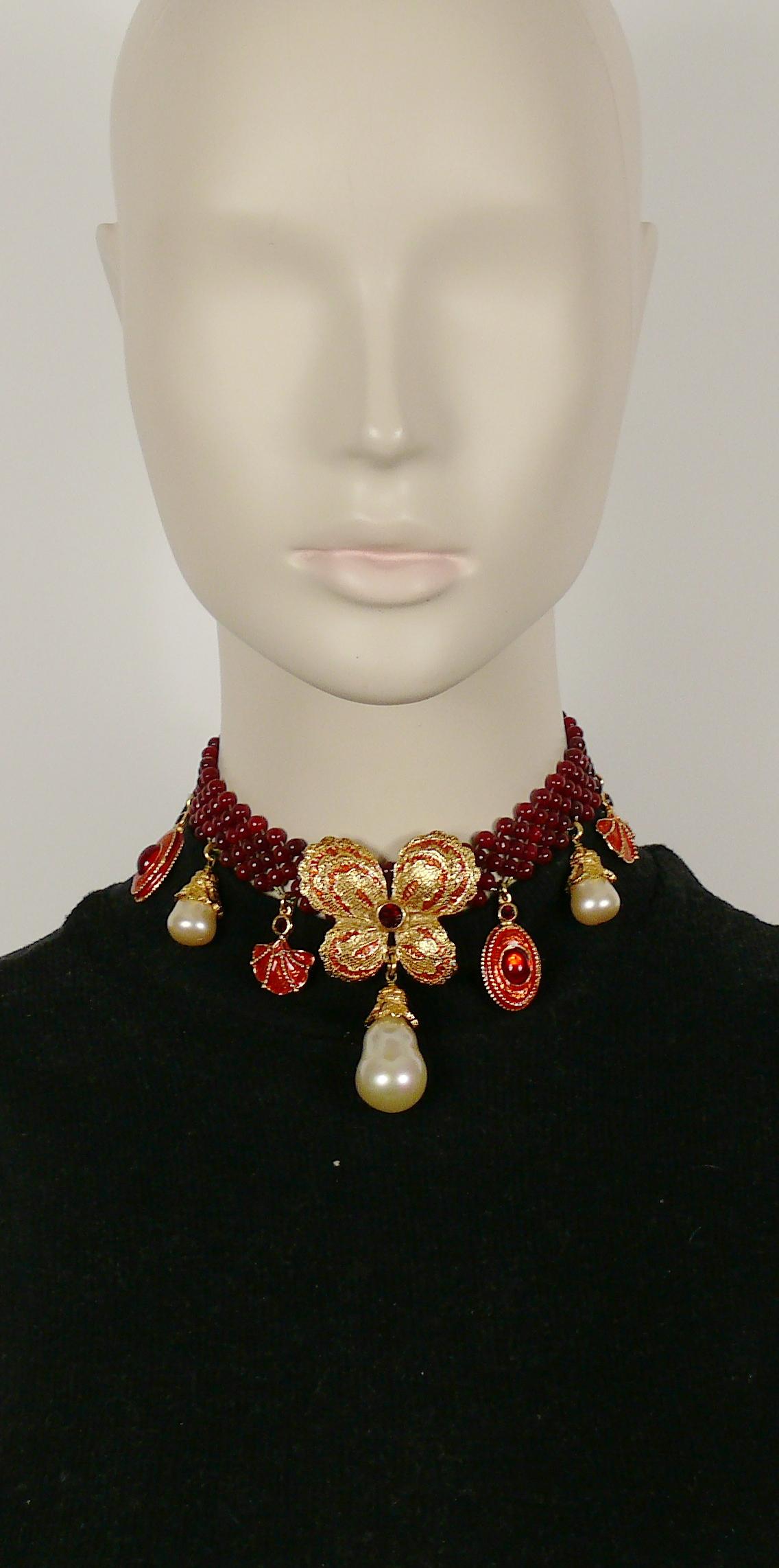 YVES SAINT LAURENT vintage ruby red glass bead choker necklace featuring a massive enameled butterfly center, charms, faux pearl drops, glass cabochons and crystal embellishement.

Adjustable hook clasp closure.

Embossed YVES SAINT LAURENT RIVE