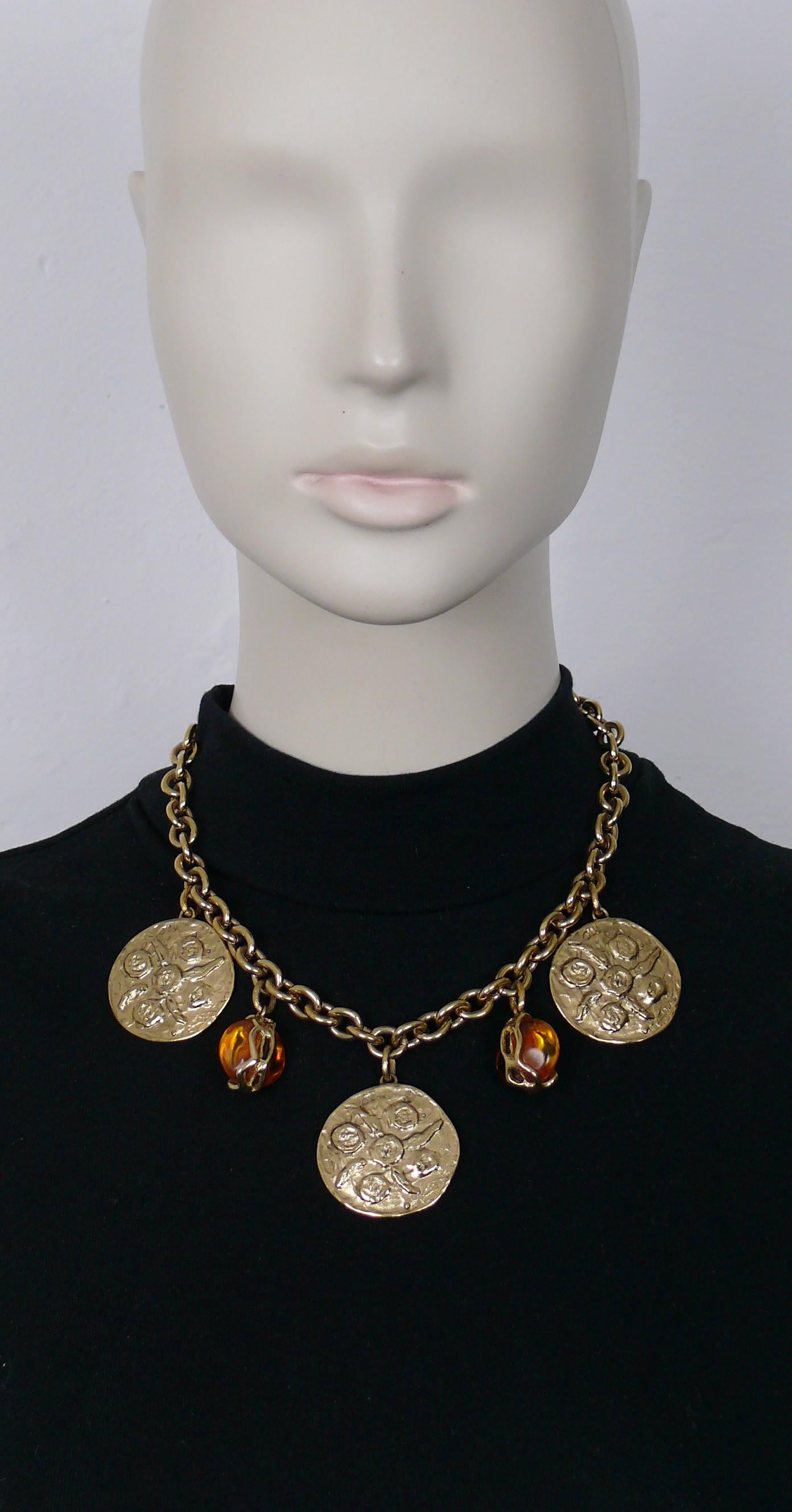 YVES SAINT LAURENT vintage gold toned chain necklace featuring three textured coins and two orange resin drops in a gold toned setting.

Spring clasp closure.
Adjustable length.

Embossed YSL on the clasp.
Hanging metal tag marked embossed