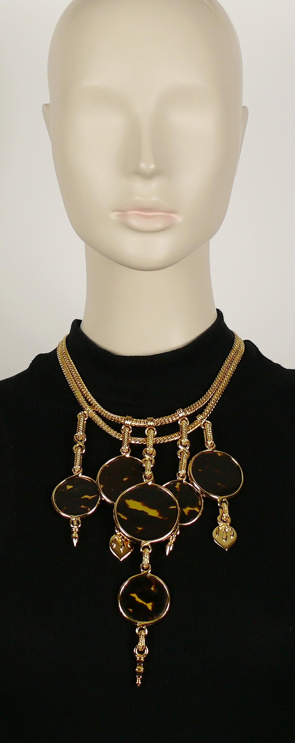 YVES SAINT LAURENT vintage gold toned chain statement necklace featuring 6 faux tortoise shell discs with charms.

Lobster clasp closure.
Adjustable length.

Can be worn on both sides.

Embossed YSL Made in France.

Indicative measurements :