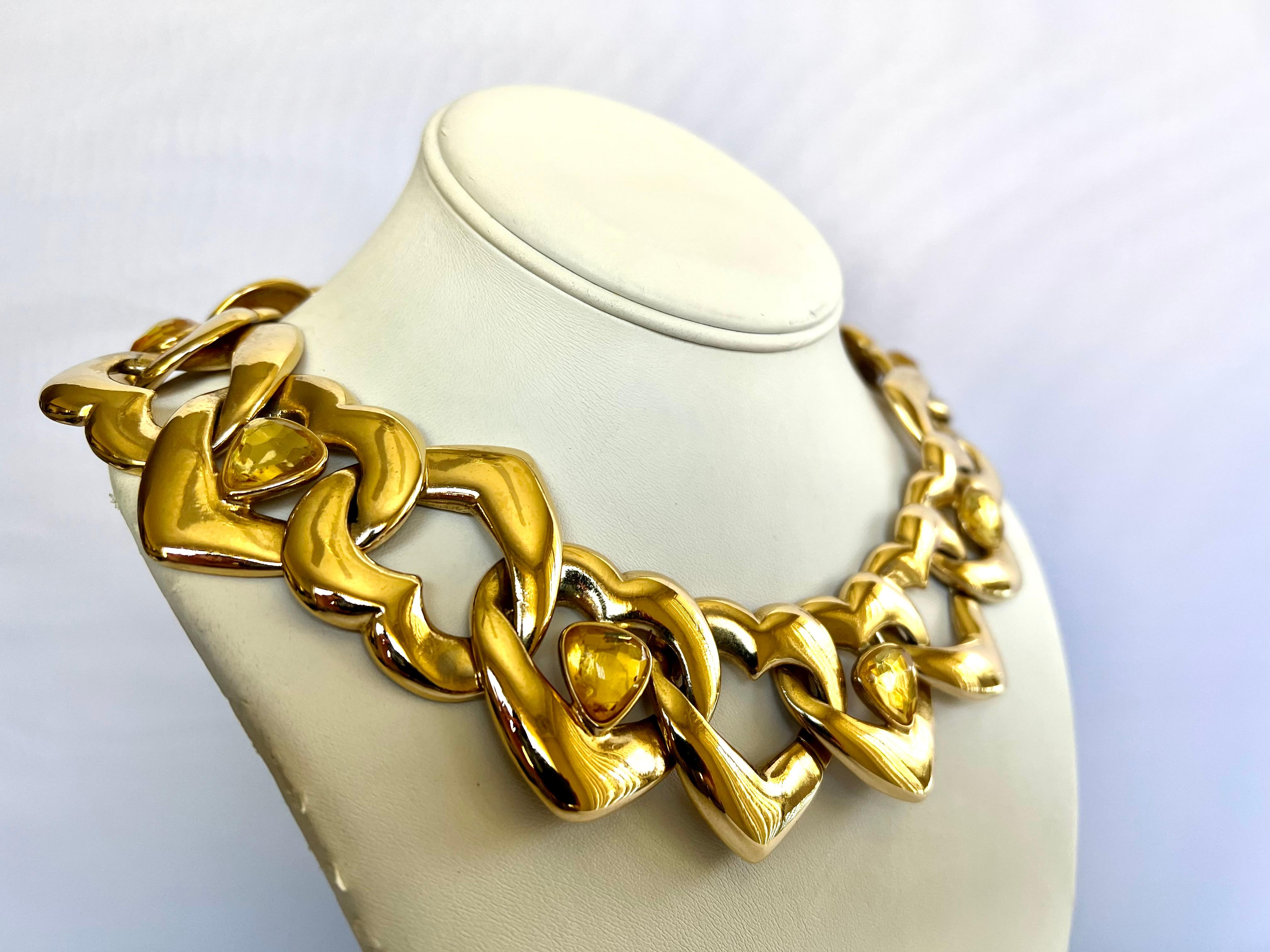 Highly collectible vintage YSL Yves Saint Laurent polished gilt heart link articulated necklace with yellow faceted acrylic embellishments. The necklace is finished with a shepherd's hook bearing the YSL stamp, made in France.