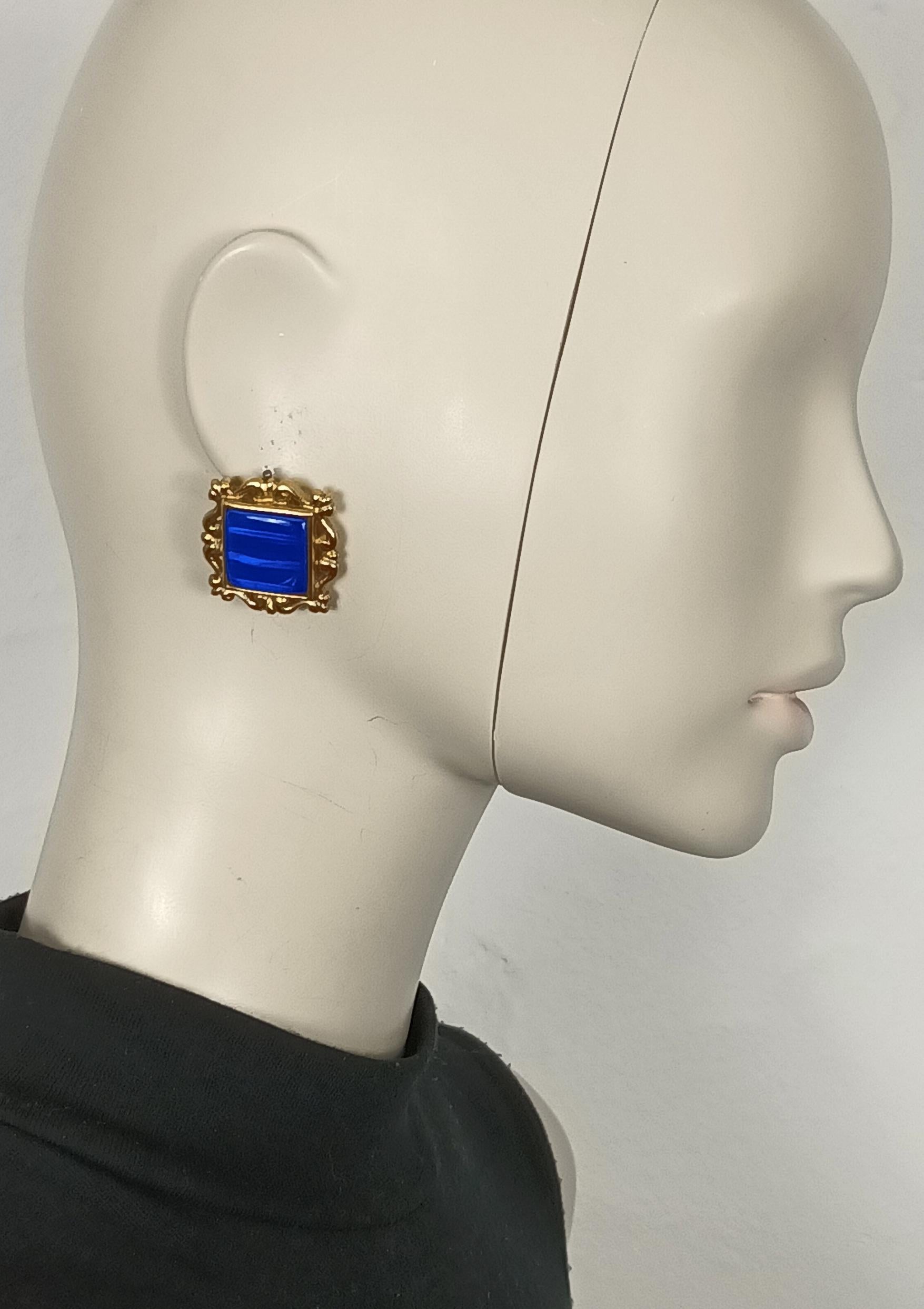 YVES SAINT LAURENT vintage gold tone clip-on earrings featuring a square blue iridescent resin cabochon at the center.

Embossed YSL Made in France.

Indicative measurements : max. 2.9 cm x max. 2.9 cm (1.14 inches x 1.14 inches).

Weight per