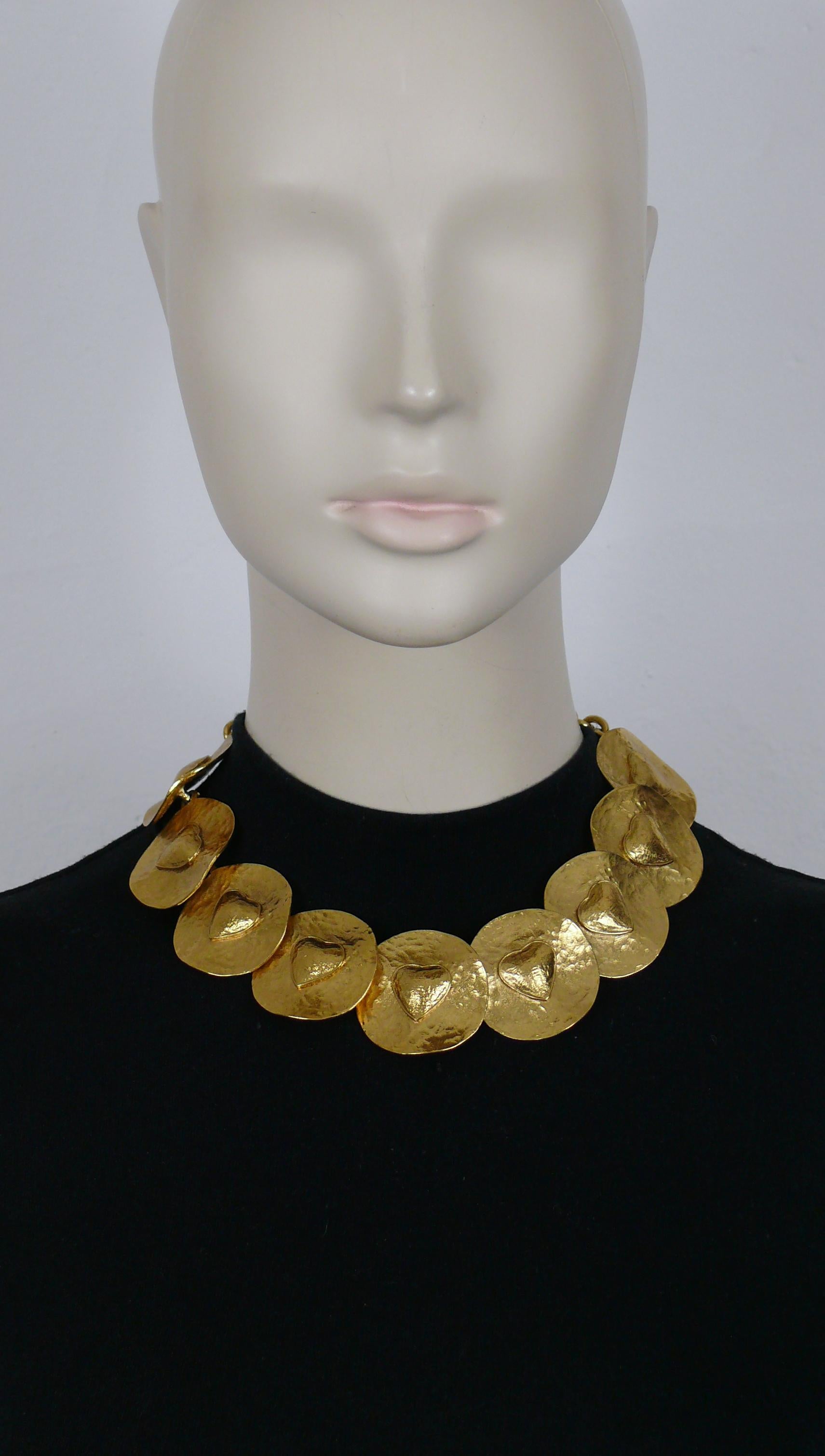 YVES SAINT LAURENT vintage gold tone necklace featuring textured creased discs, each with heart at the center.

Adjustable T-bar and toggles closure.

Embossed with the cursive YVES SAINT LAURENT signature on the heart toggles.
Embossed YSL Made in