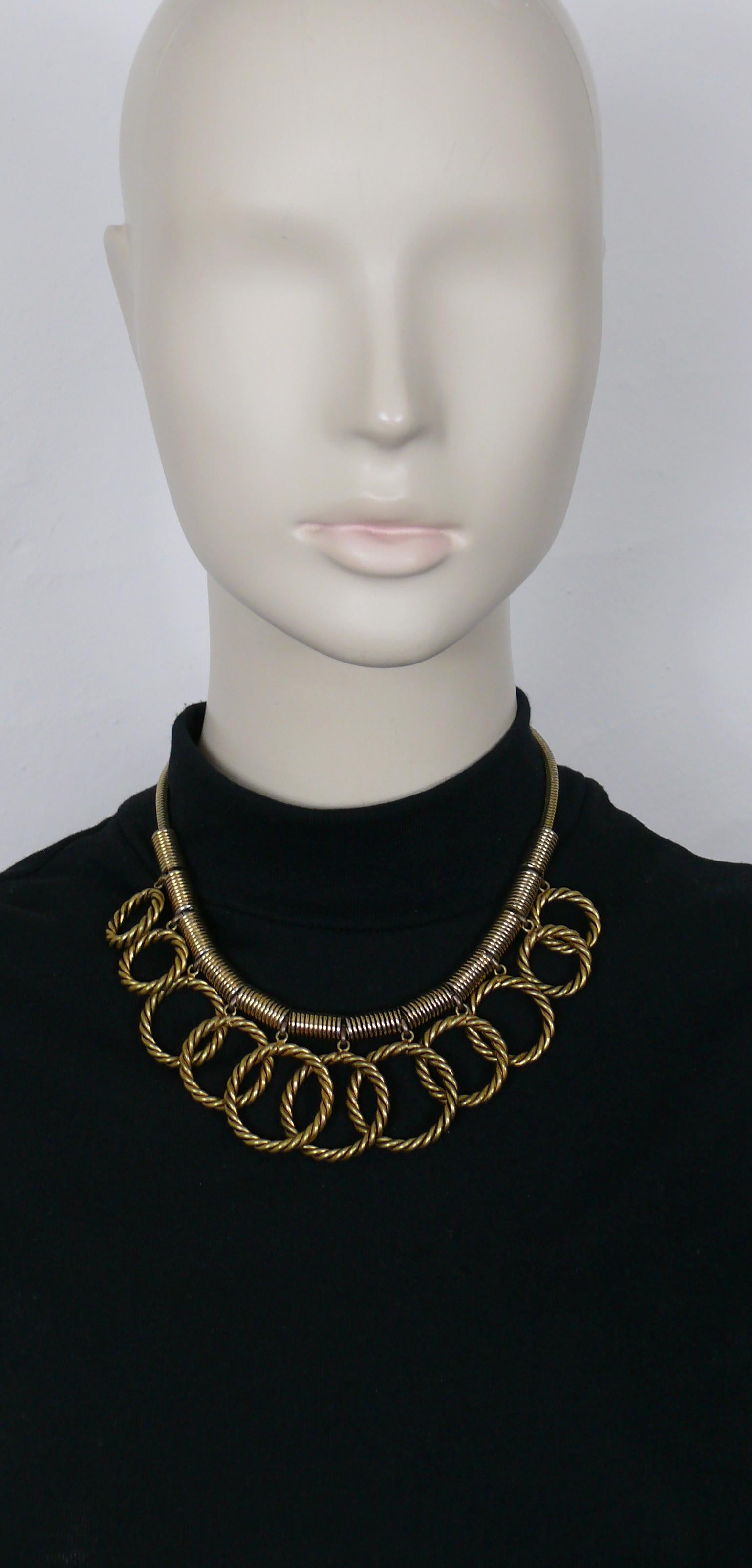 YVES SAINT LAURENT vintage gold toned necklace featuring eleven graduated twisted circles charms.

Adustable hook closure.

Embossed YSL FRANCE on the S hook.

Indicative mesaurements : adjustable length from approx. 41 cm (16.14 inches) to approx.