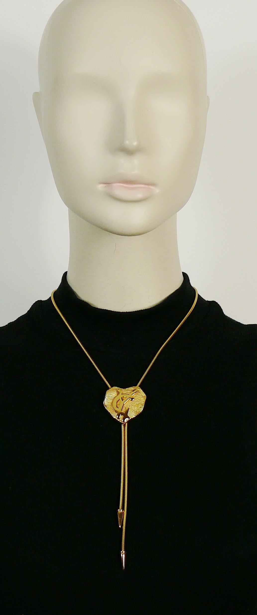 YVES SAINT LAURENT vintage gold toned snake chain necklace featuring a ribbed heart pendant with embossed YSL logo.

Adjustable toggle clasp closure.

Marked YSL Made in France and YVES SAINT LAURENT signatures on the closures.

Indicative
